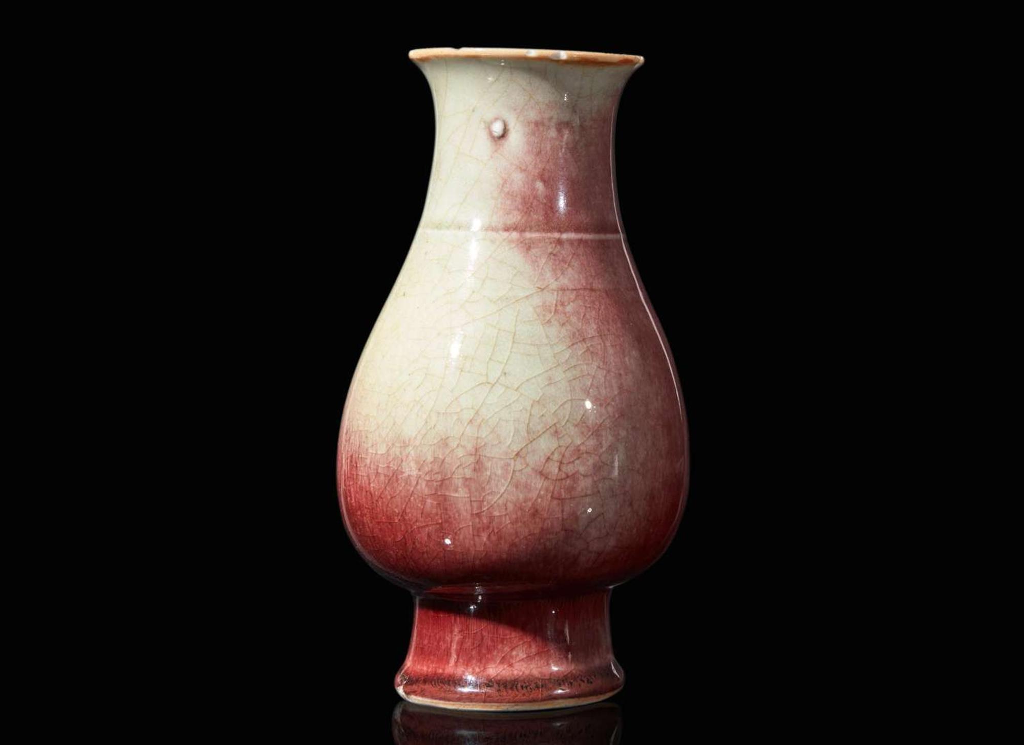 A Chinese copper-red glazed porcelain vase, Qing dynasty 銅紅釉觶瓶 清