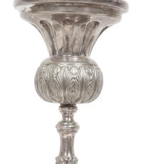 A Set of Four Continental Silvered Metal Candlesticks