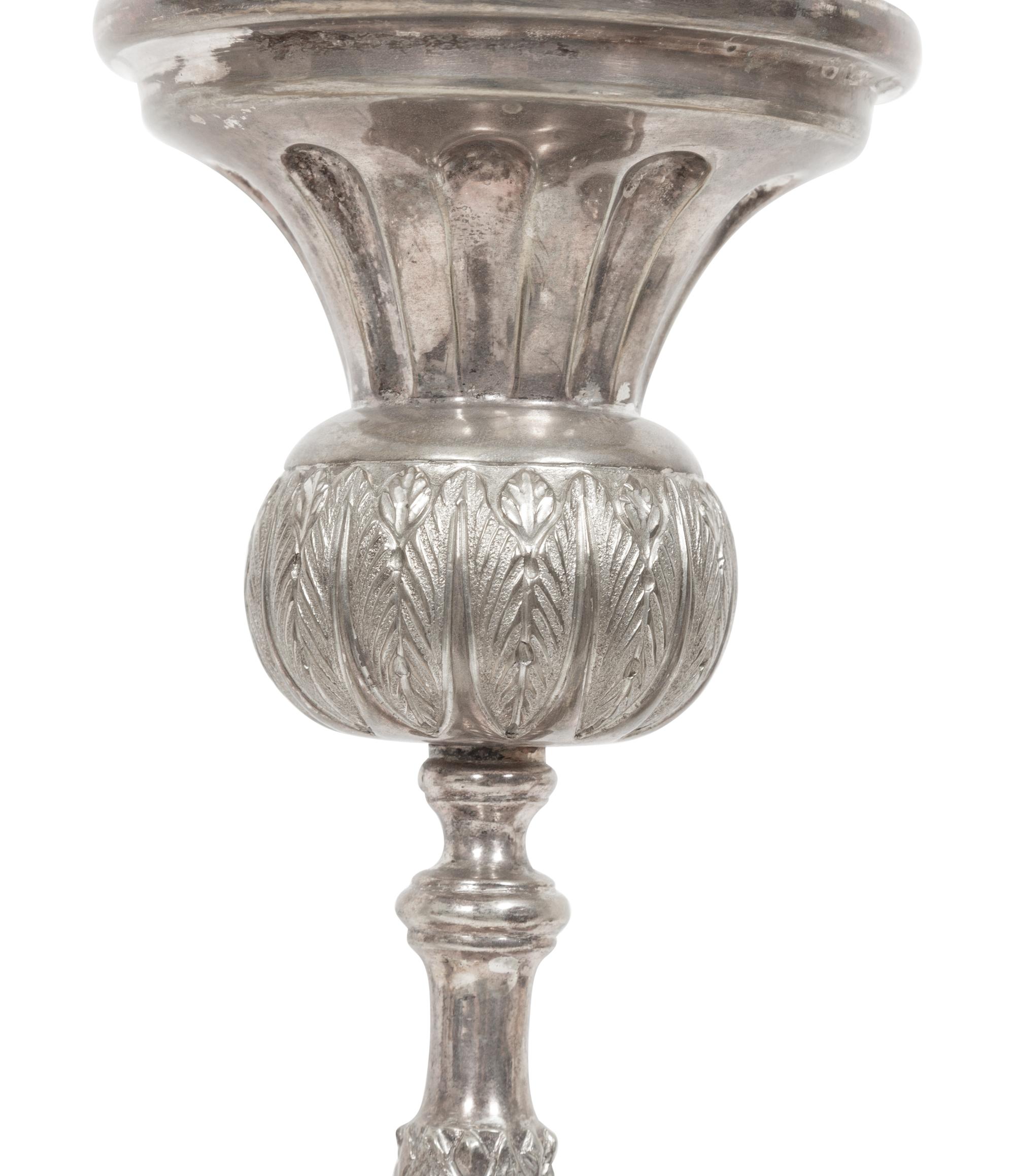 A Set of Four Continental Silvered Metal Candlesticks