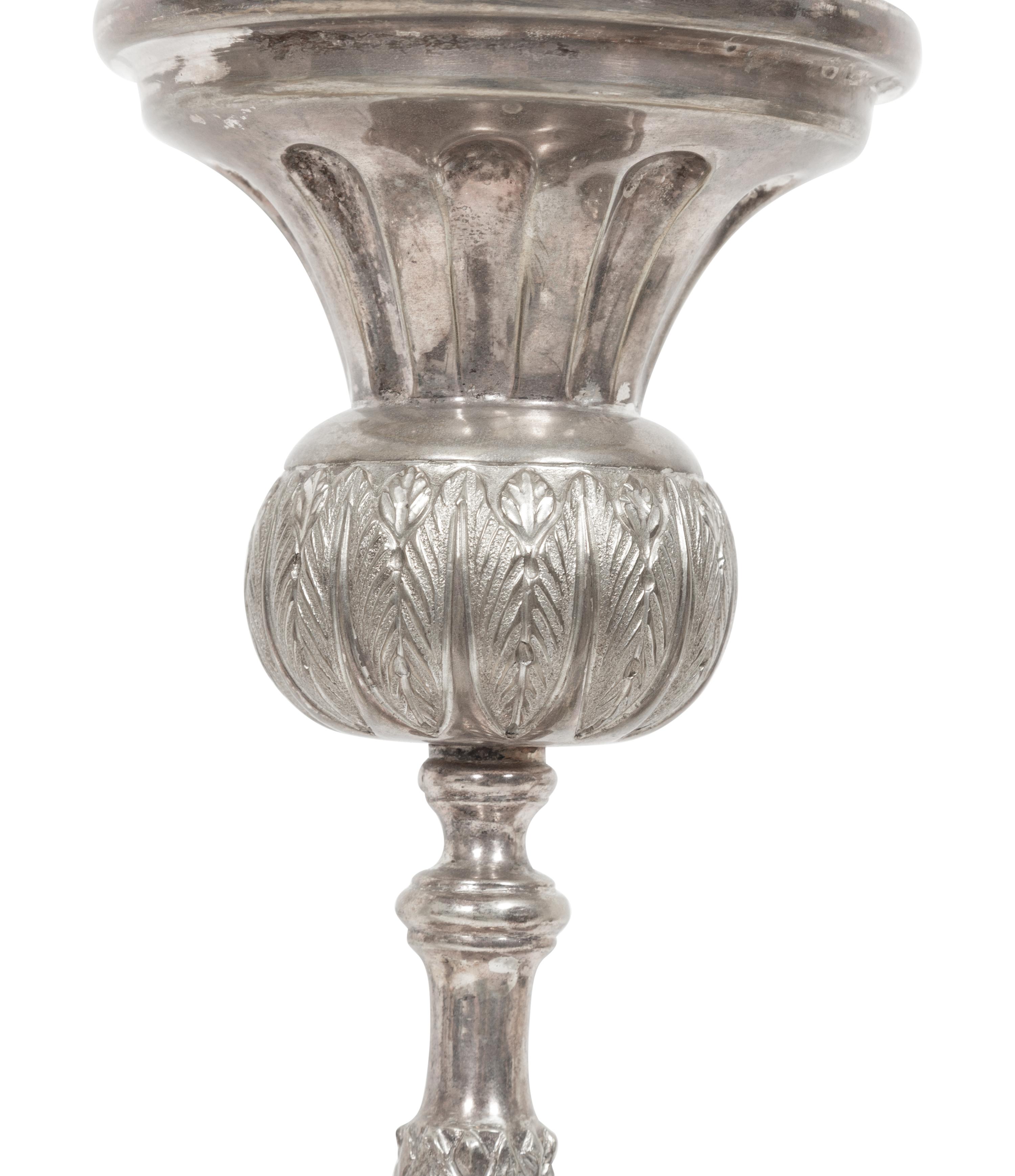 A Set of Four Continental Silvered Metal Candlesticks
