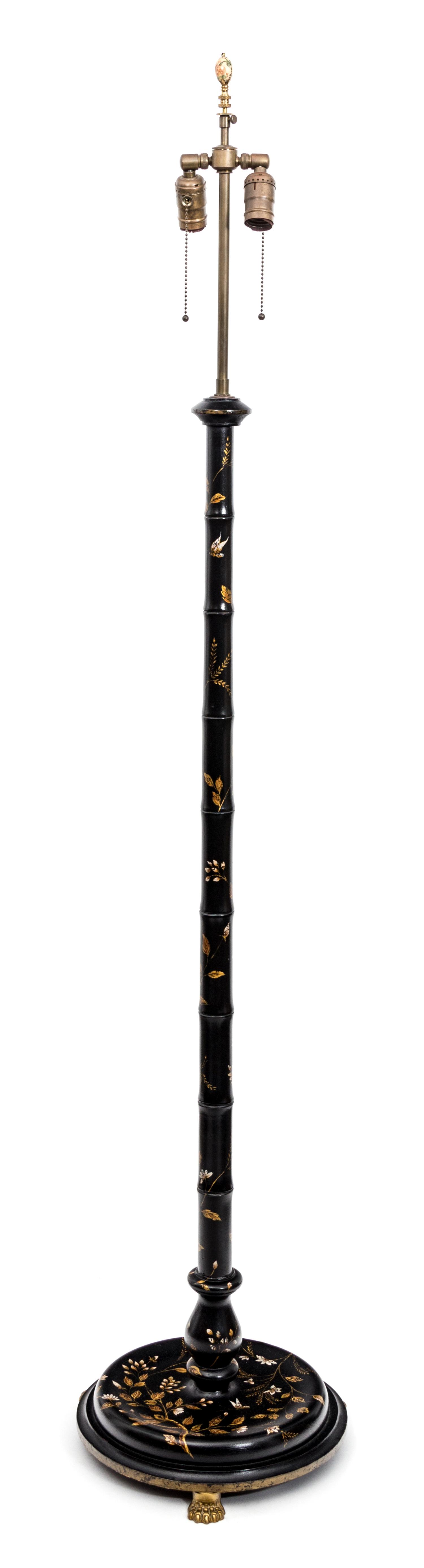 A Regency Style Faux Bamboo Black and Gilt-Japanned Standing Lamp Height 65 inches.