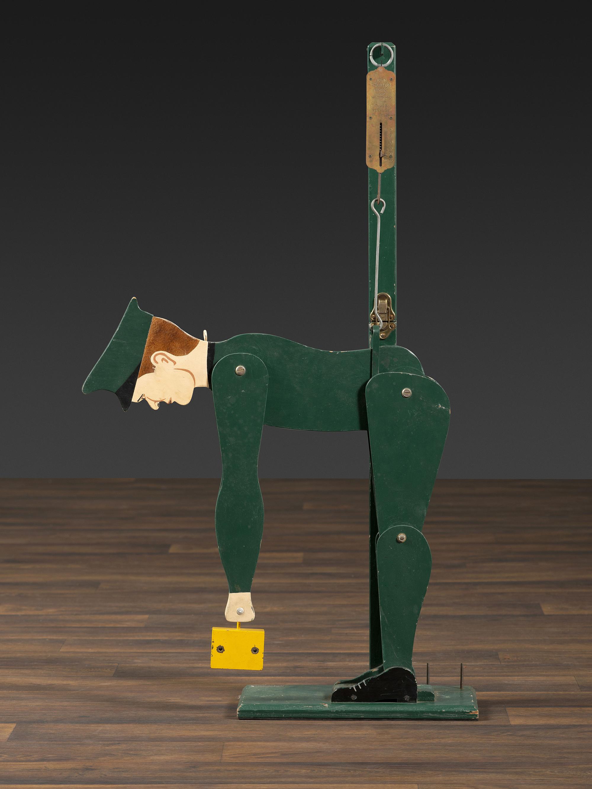 A Carved and Painted Wood Figural Post Office Scale