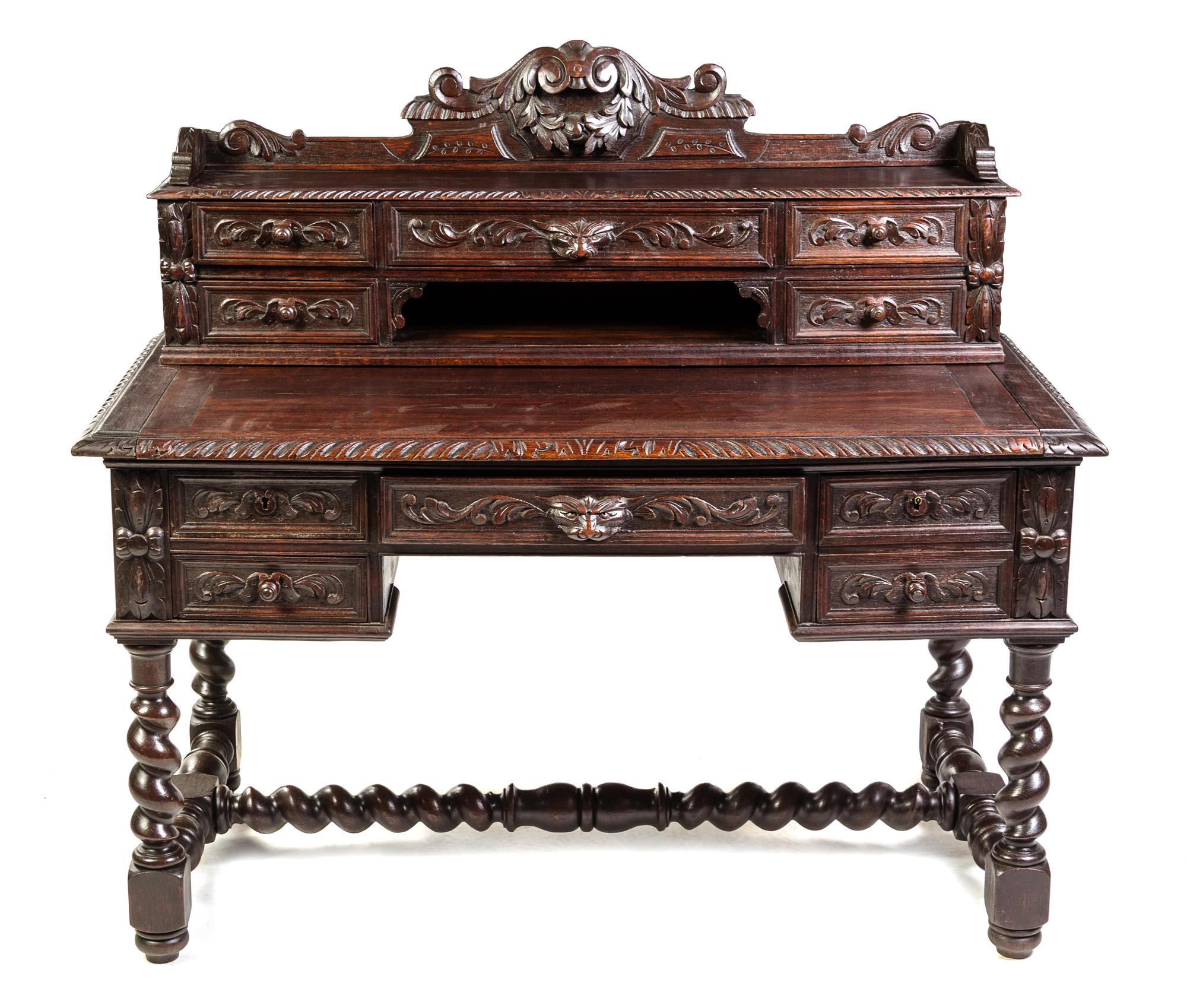 A Renaissance Revival Carved Oak Writing Desk Height 46 x width 51 1/4 x depth 26 inches. — LATE 19TH CENTURY