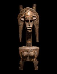 A Bamana Wood Marionette Figure with Eight Wood Puppet Heads