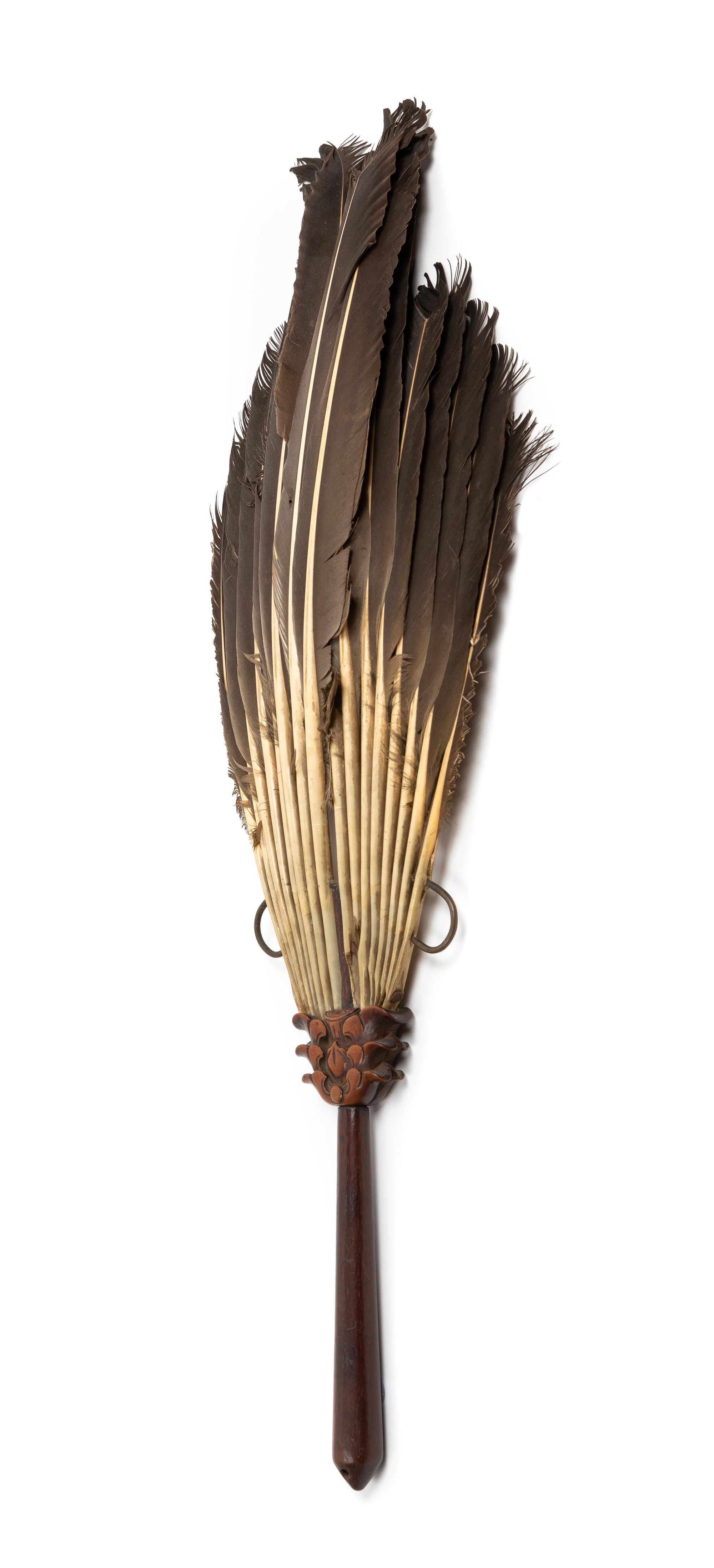 A Chinese Carved Hongmu Feathered Fan Length 19 inches. — QING DYNASTY (1644-1912)