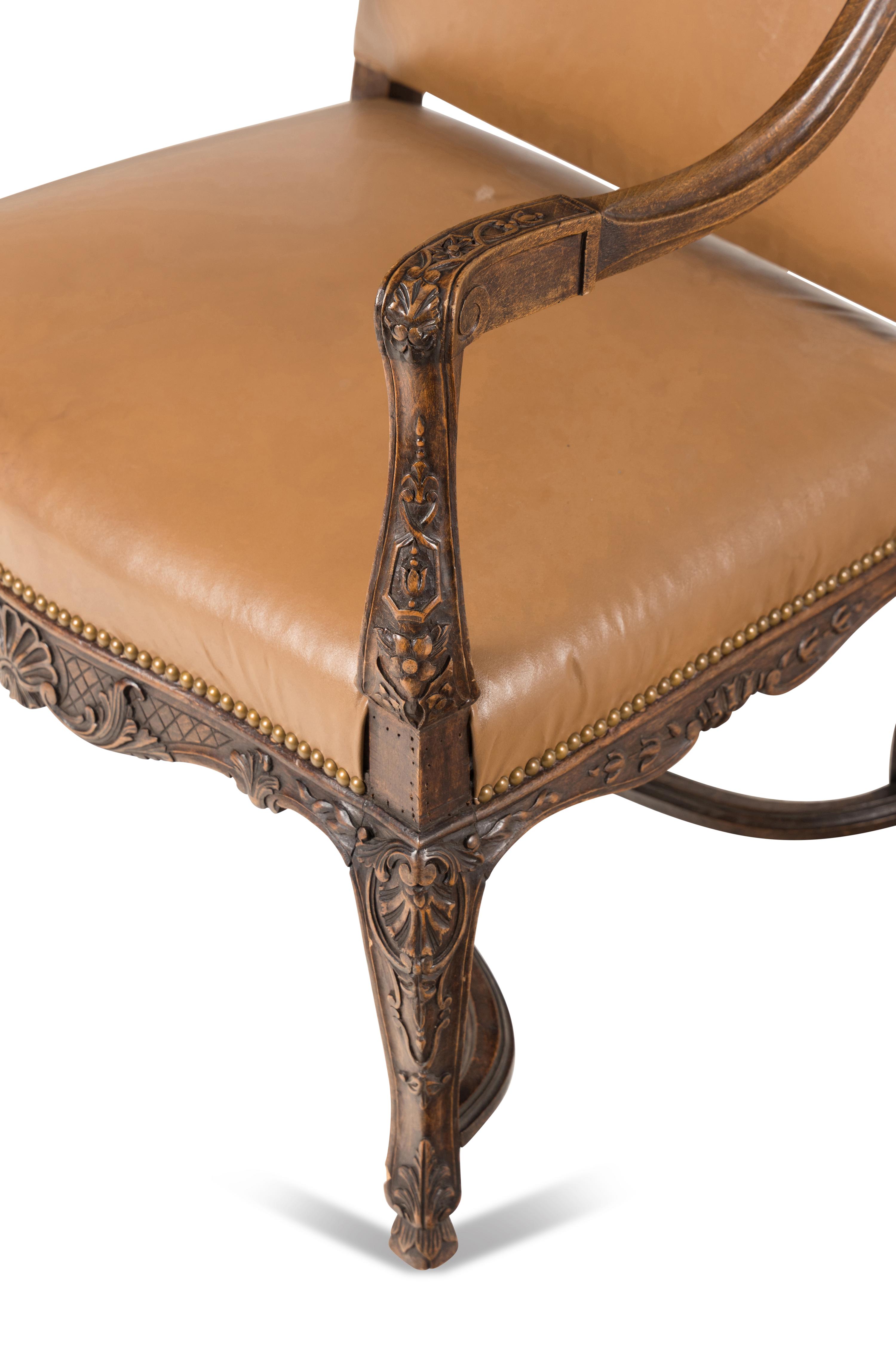 A Matched Pair of Régence Style Walnut Fauteuils