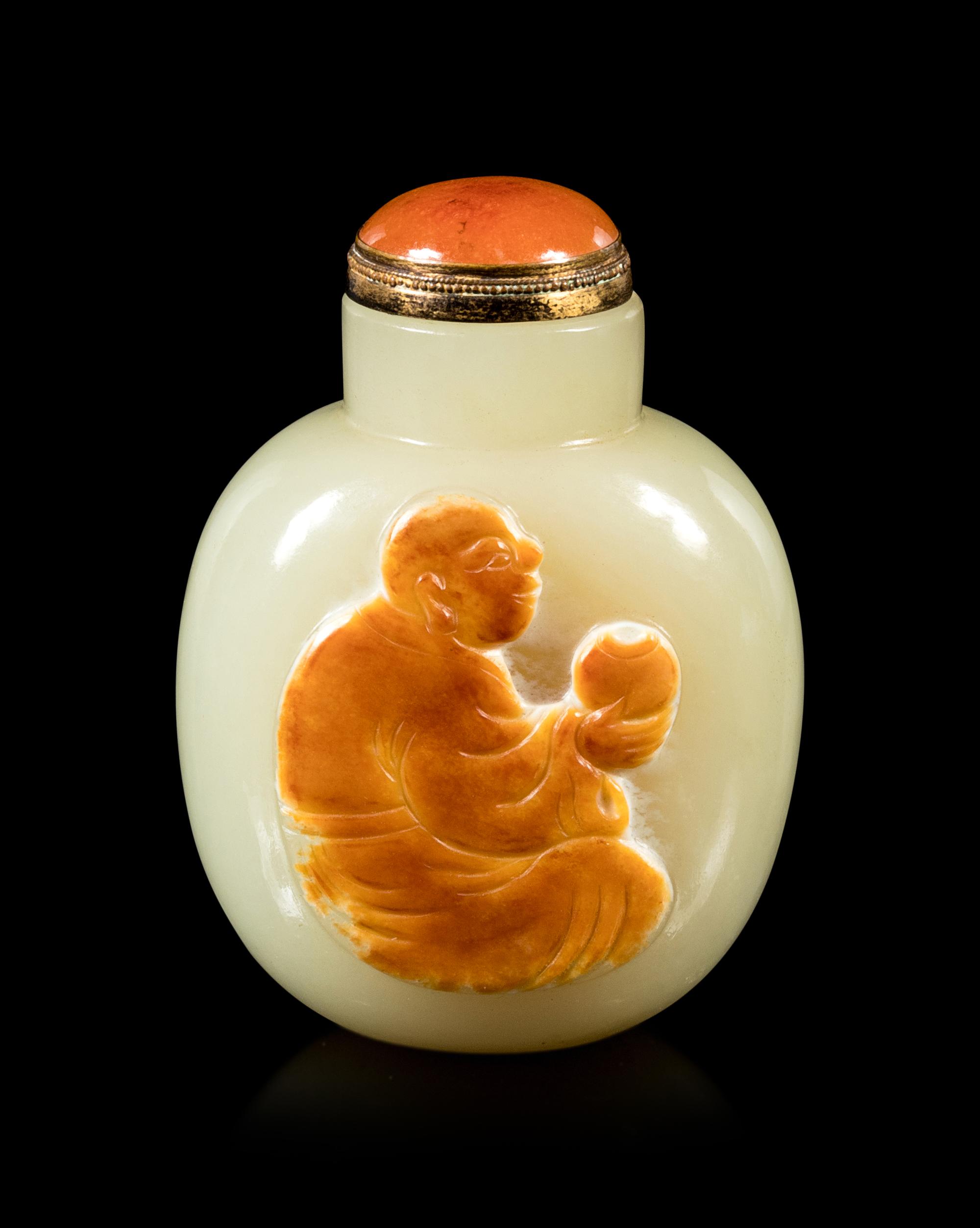 A Carved Russet and Celadon Jade Snuff Bottle