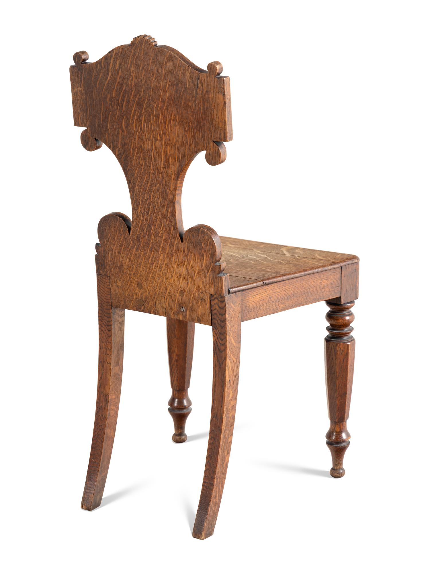 A Pair of William IV Carved Oak Hall Chairs