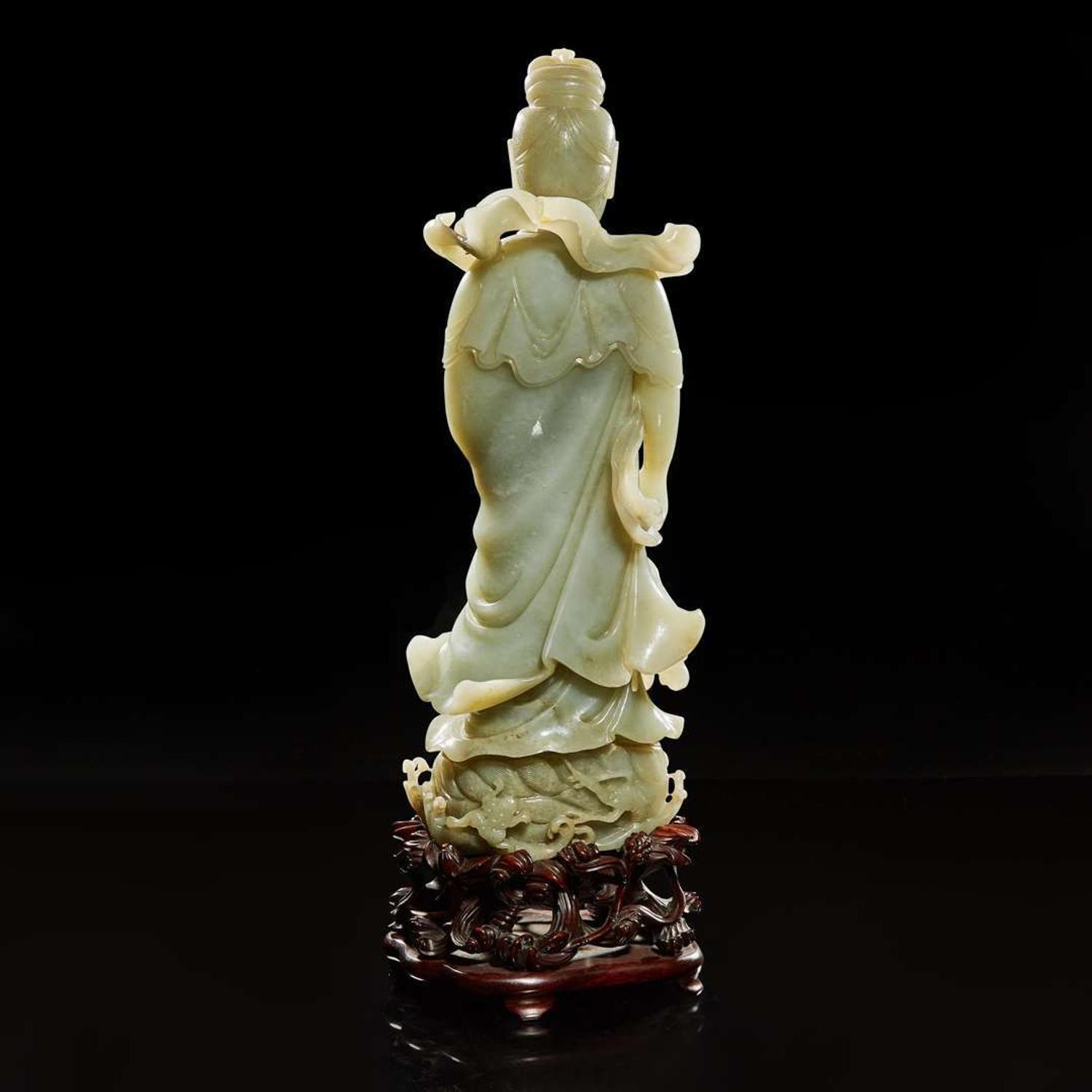 A large Chinese carved celadon jade figure of a bodhisattva 青玉雕觀音 Late Qing to Republic period ?????