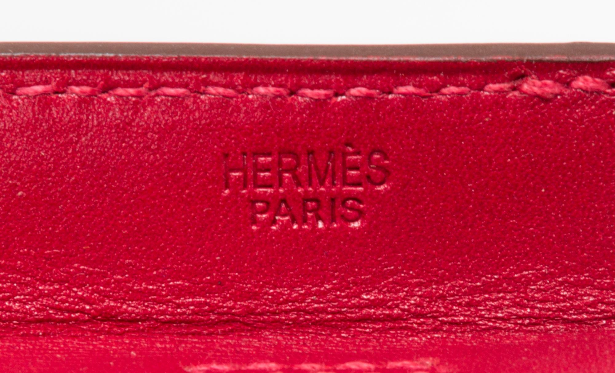 An Hermes Rouge Leather Passport Pouch, 7" x 8" x 1".