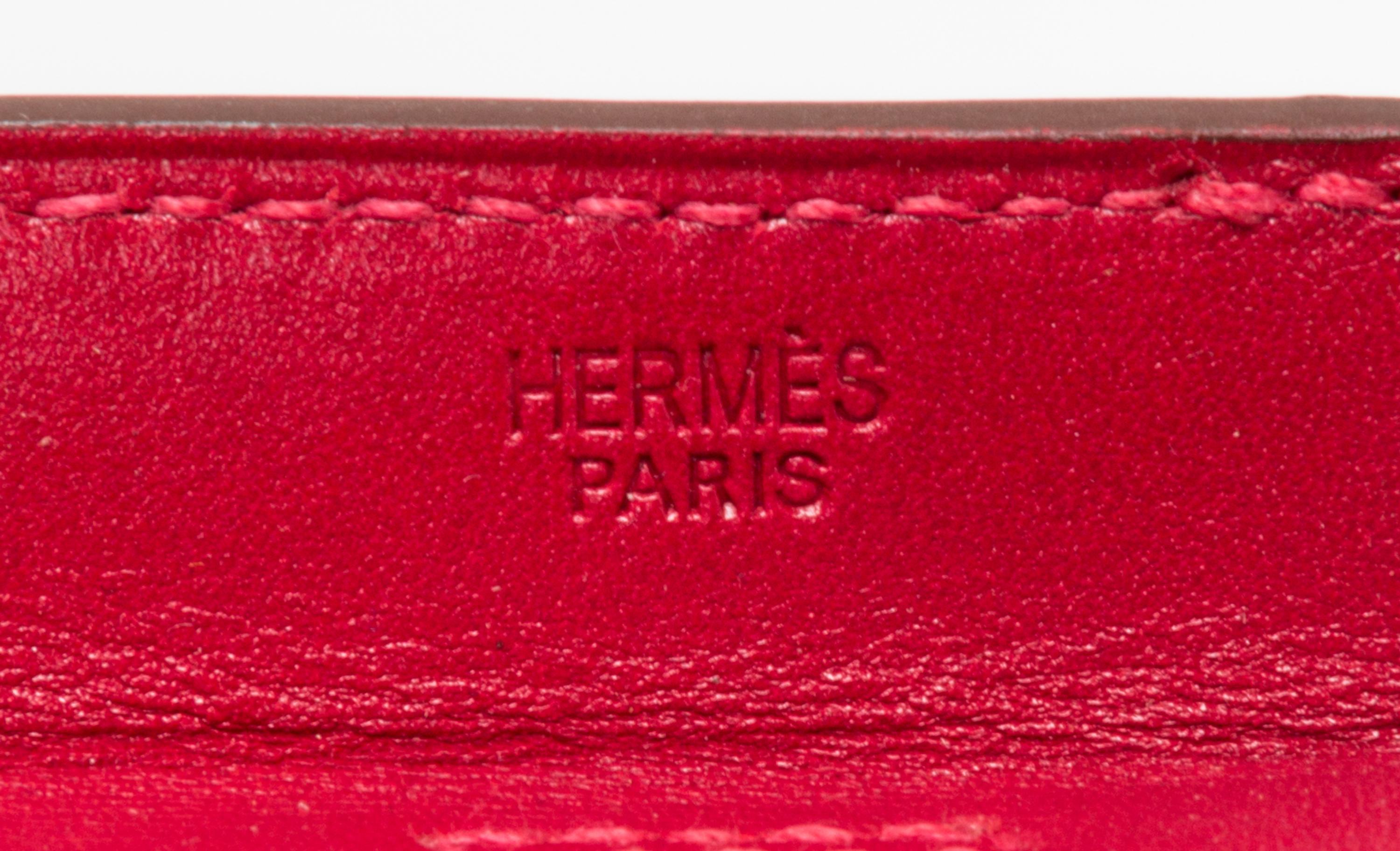 An Hermes Rouge Leather Passport Pouch, 7" x 8" x 1".