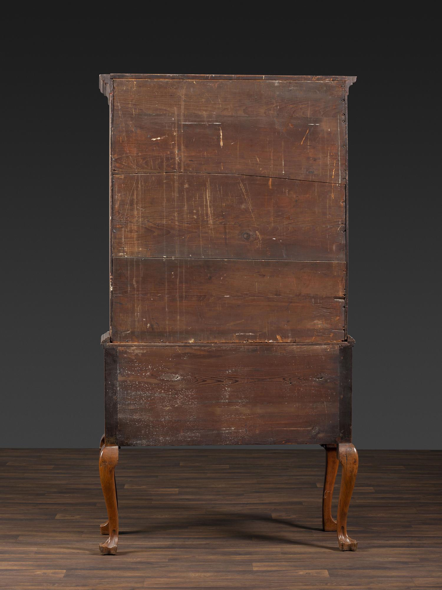 A Queen Anne Figured Walnut Flat-Top Trifid-Foot High Chest