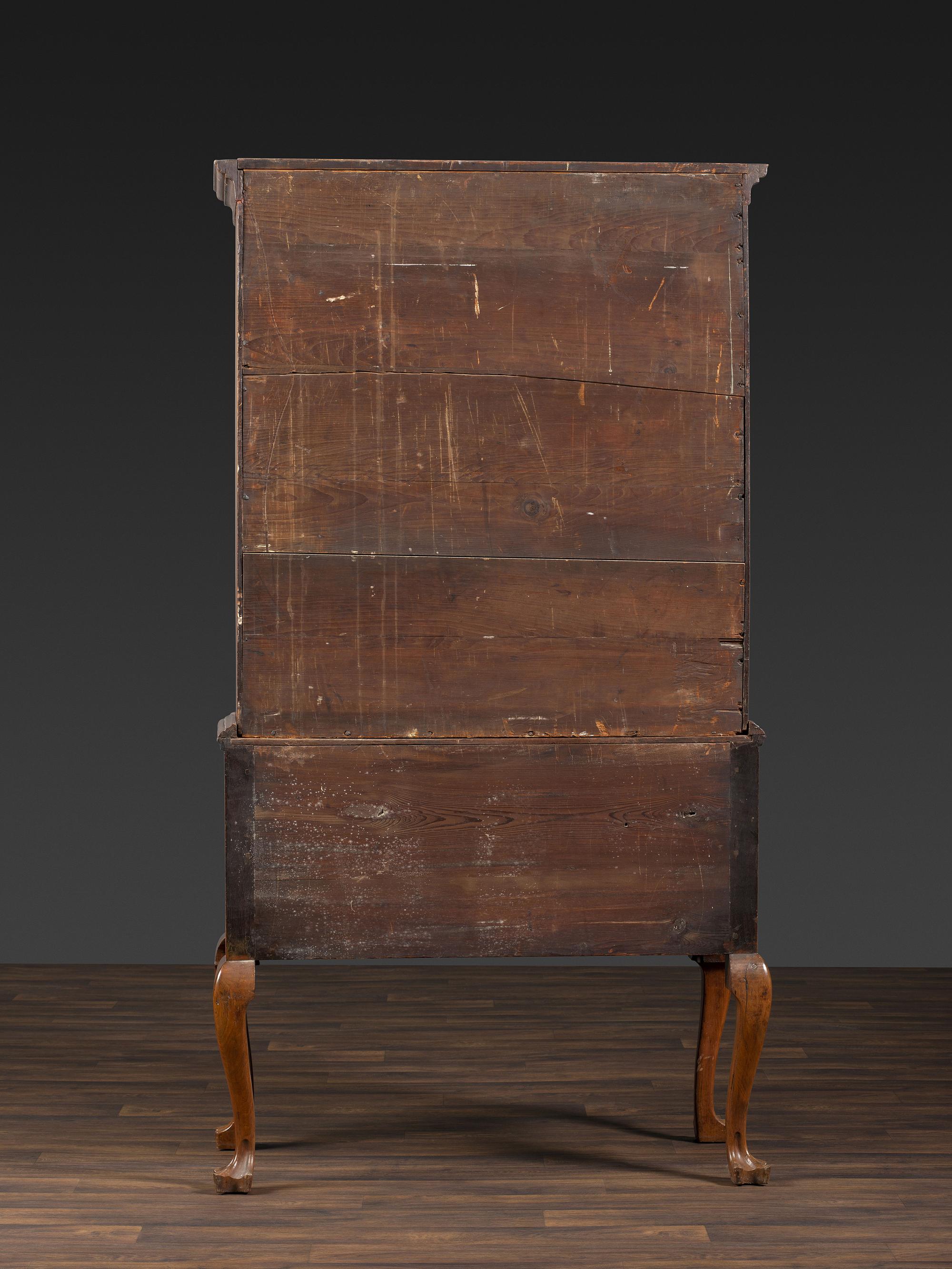 A Queen Anne Figured Walnut Flat-Top Trifid-Foot High Chest