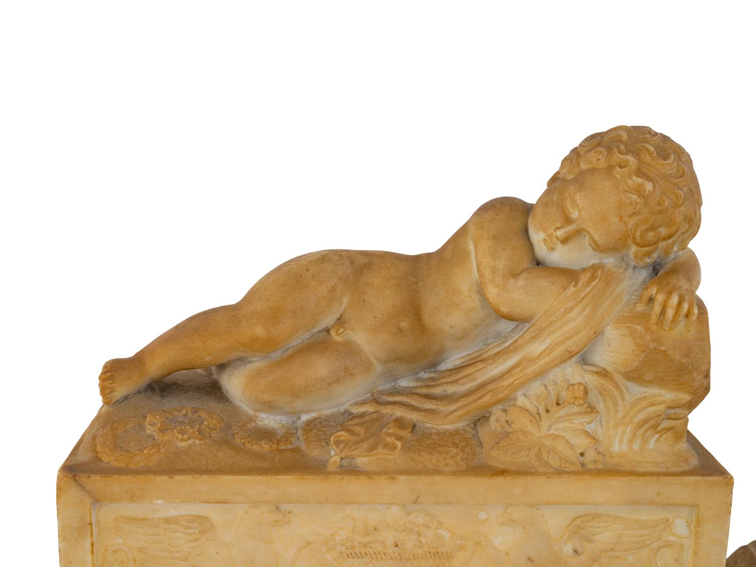 A Pair of Marble Models of Sleeping Cherubs on Plinths