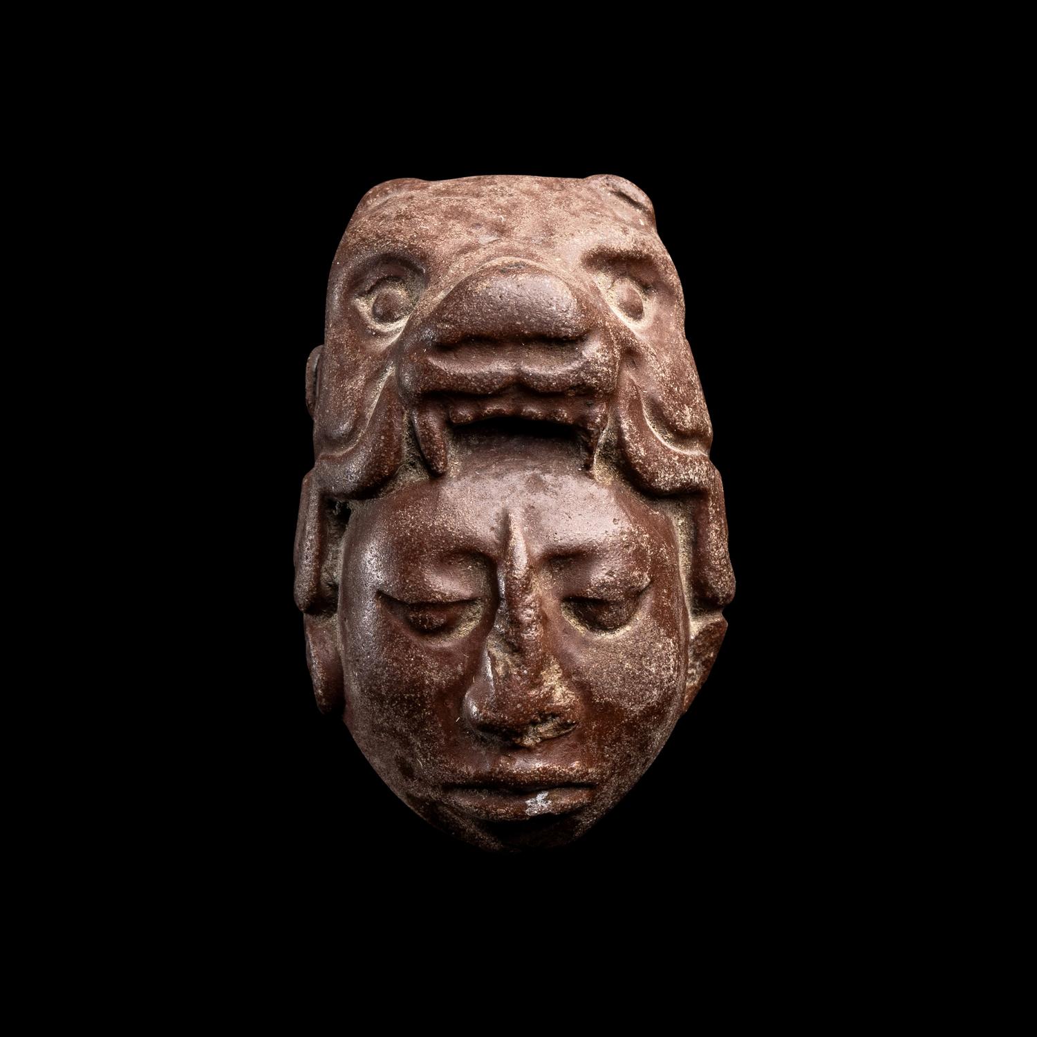 A Maya Stone Head Pendant