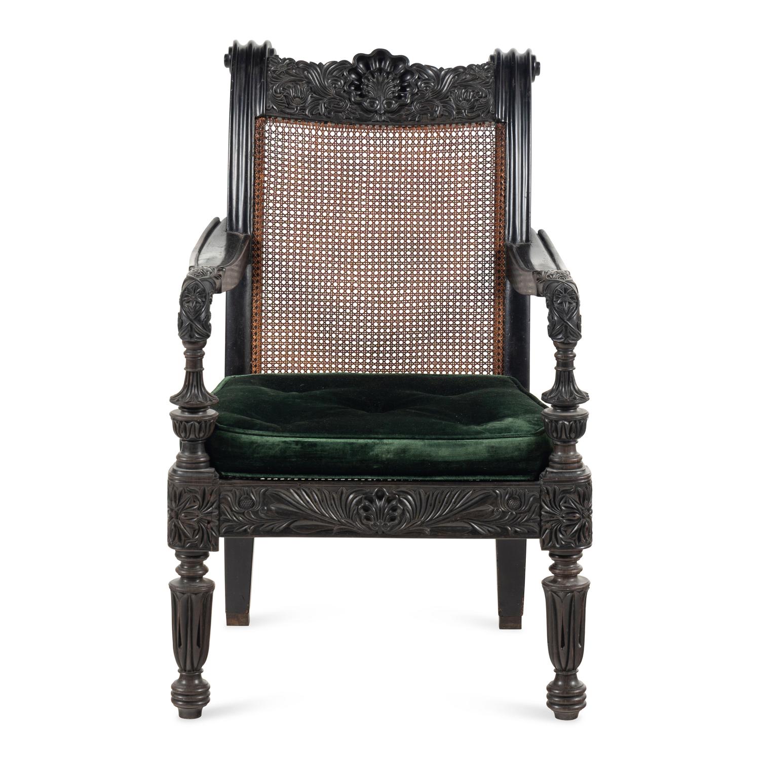 An Anglo-Colonial Carved Ebony and Caned Armchair