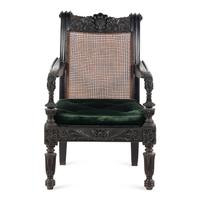 An Anglo-Colonial Carved Ebony and Caned Armchair