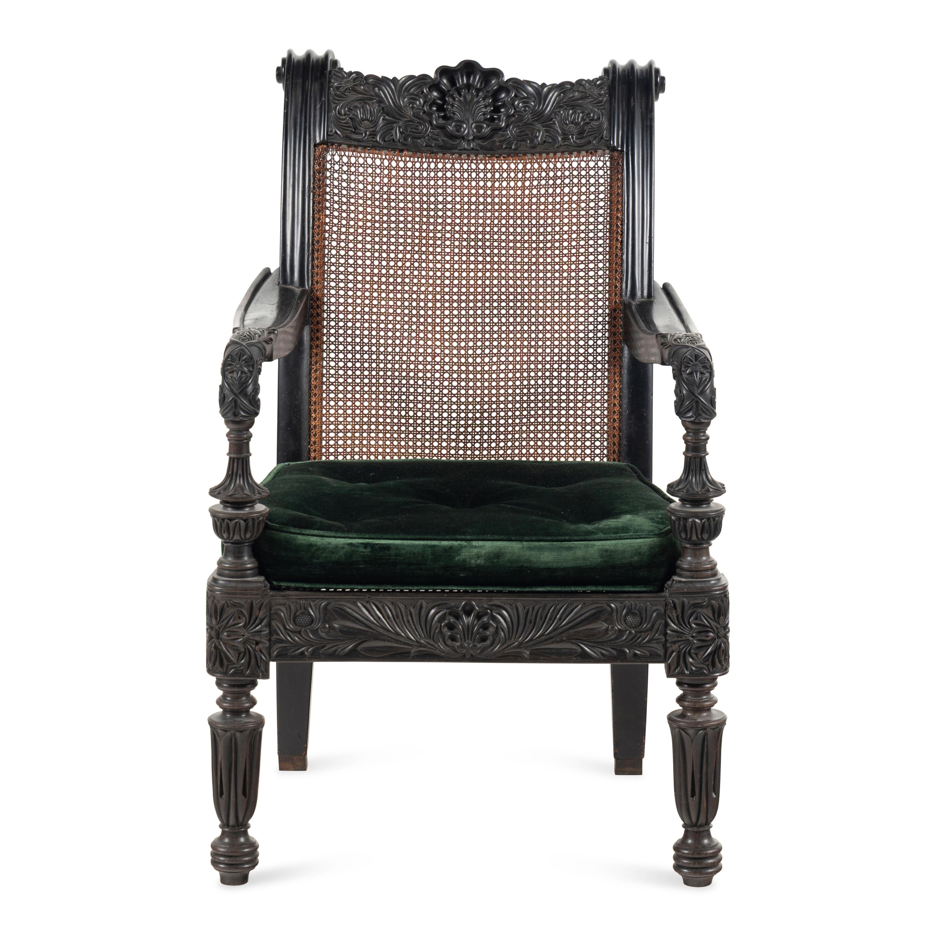 An Anglo-Colonial Carved Ebony and Caned Armchair