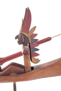 A Folk Art Whirligig of an American Indian in a Canoe