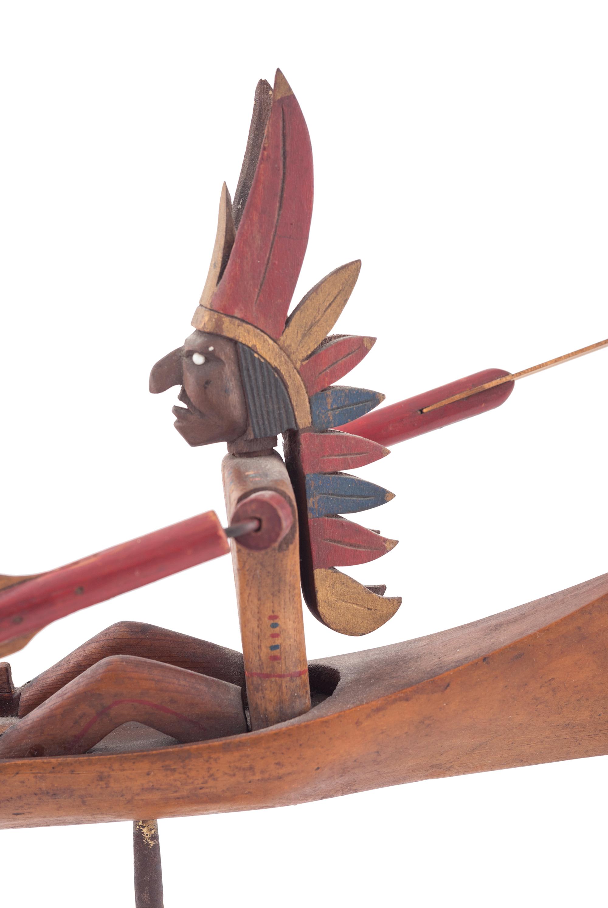 A Folk Art Whirligig of an American Indian in a Canoe