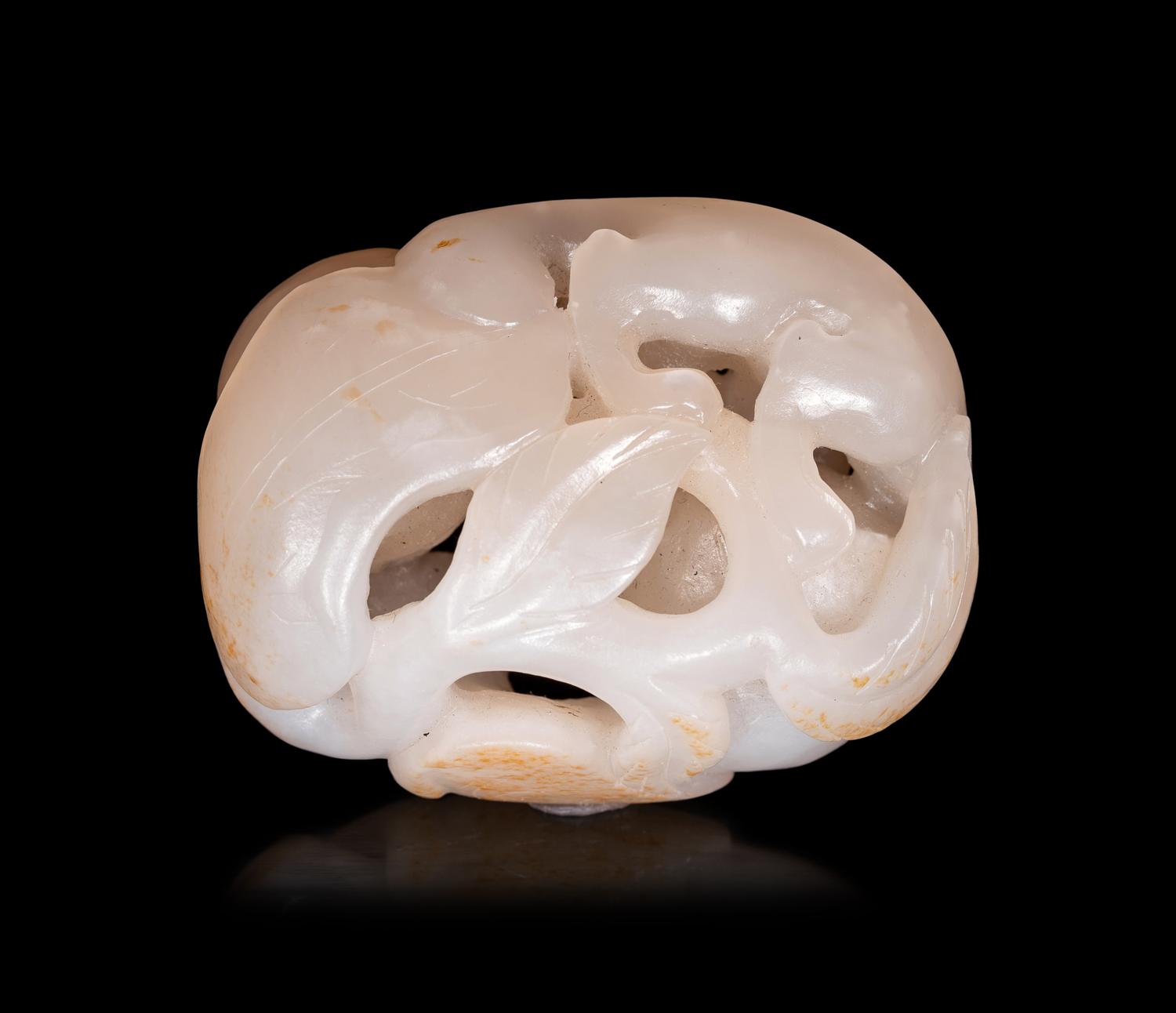 A White Jade Carving of Squirrel and Peaches
