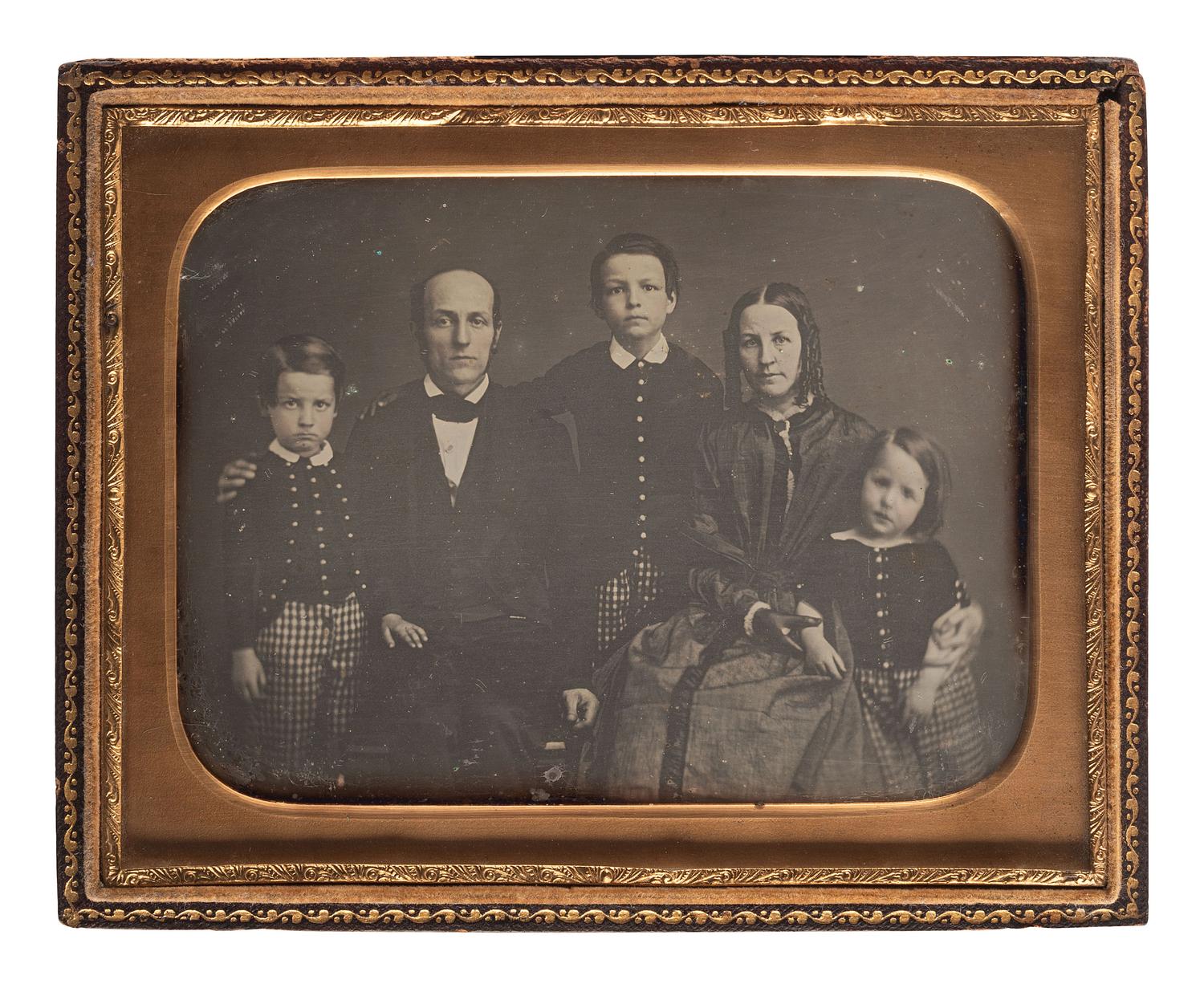 [EARLY PHOTOGRAPHY]. A charming collection of 6 family portrait daguerreotypes and one ambrotype, including: