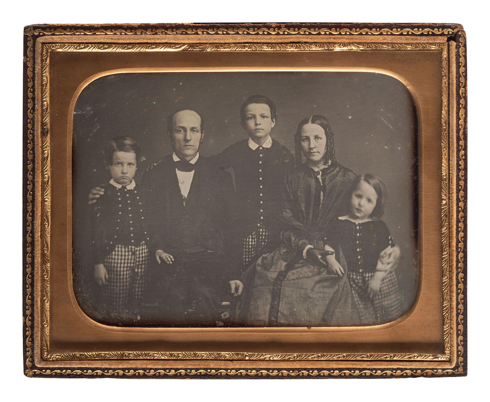 [EARLY PHOTOGRAPHY]. A charming collection of 6 family portrait daguerreotypes and one ambrotype, including: