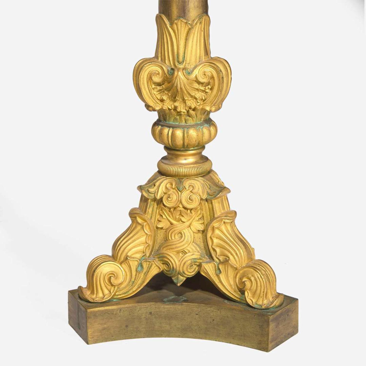 A pair of large French Louis Philippe ormolu candlesticks circa 1830-1840