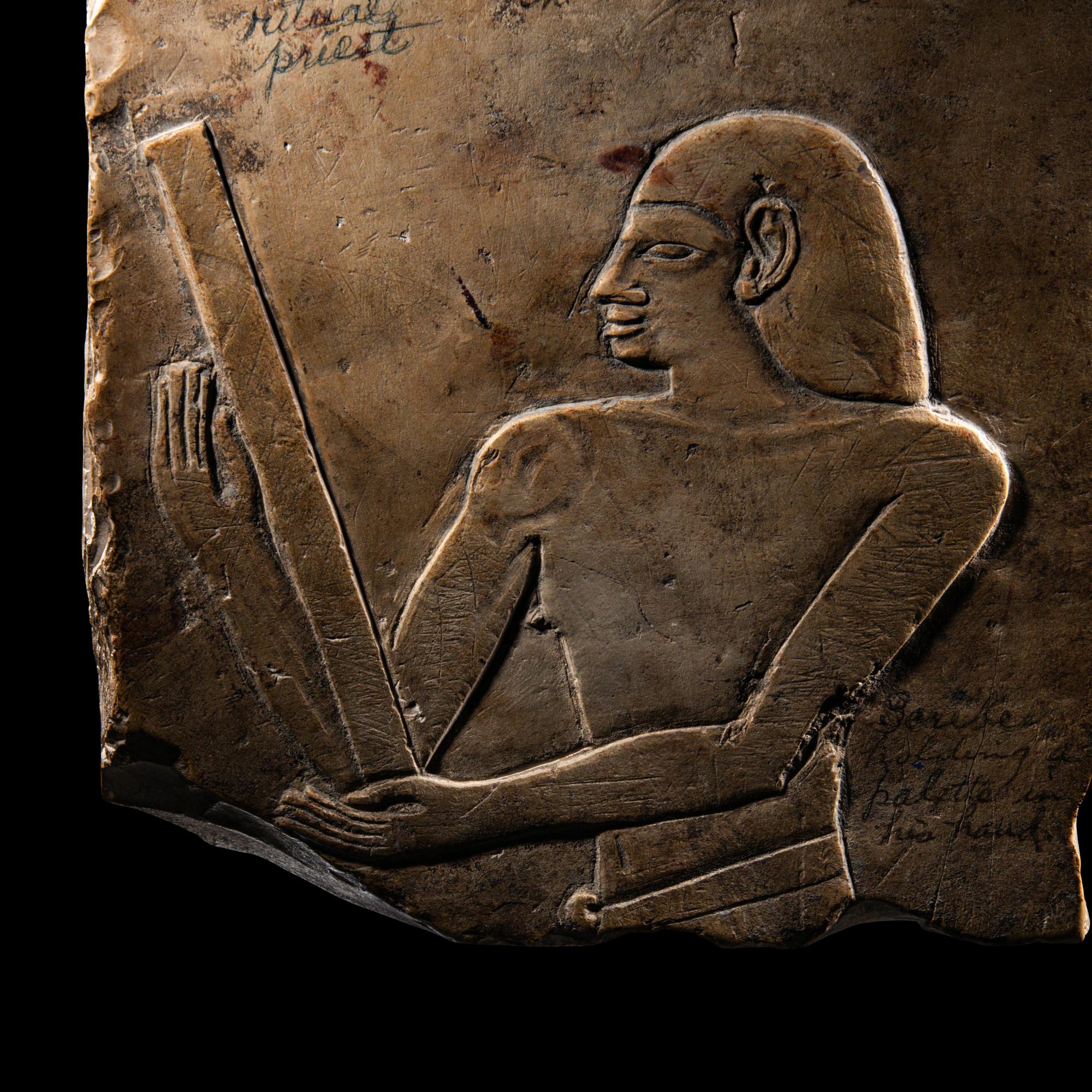 An Egyptian Limestone Relief Fragment with a Priest