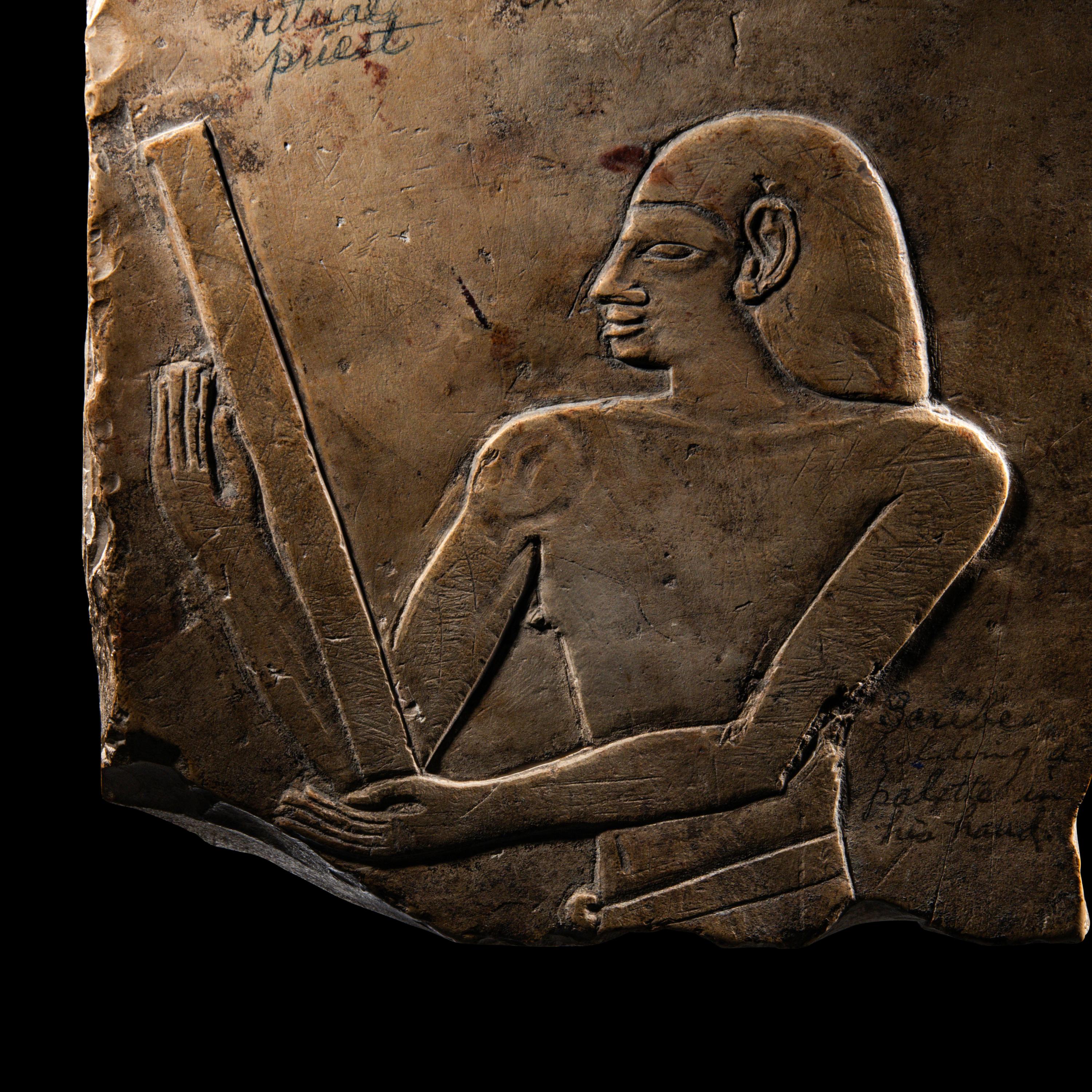 An Egyptian Limestone Relief Fragment with a Priest
