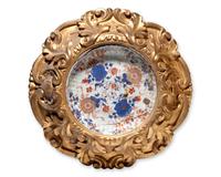 A Chinese Imari porcelain dish mounted in giltwood frame, circa 1700 and later