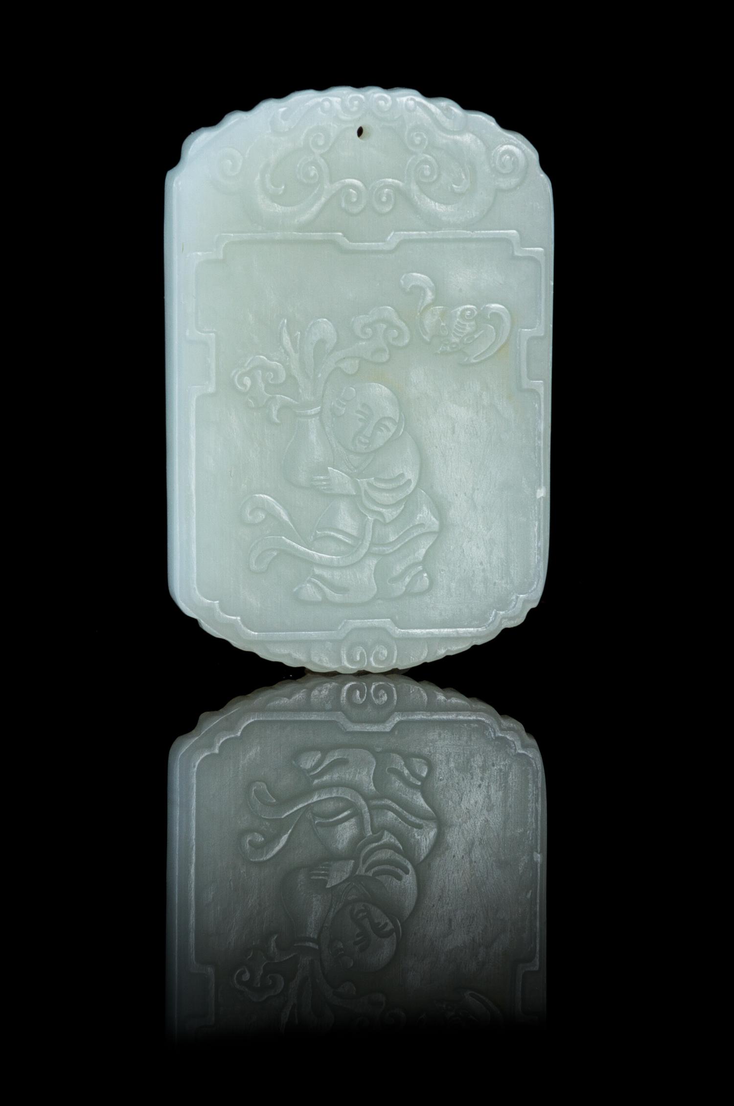 A Carved Pale Celadon Jade Plaque Height 2 1/8 inches.