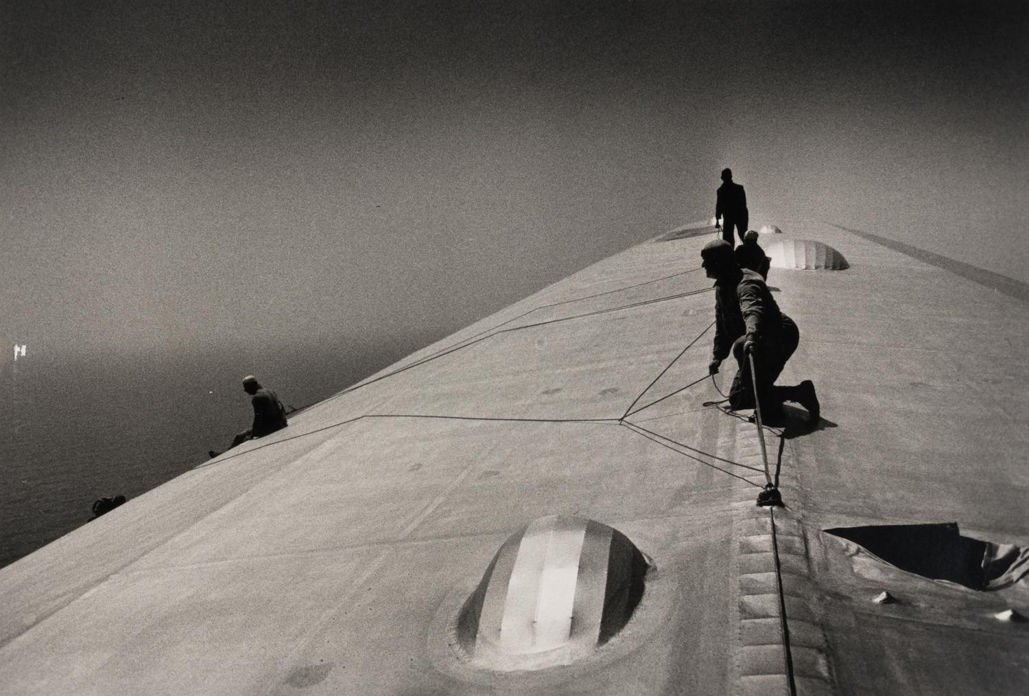 EISENSTAEDT, Alfred (1898-1995). A photograph of workers repairing the hull of the Graf Zeppelin.