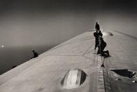 EISENSTAEDT, Alfred (1898-1995). A photograph of workers repairing the hull of the Graf Zeppelin.