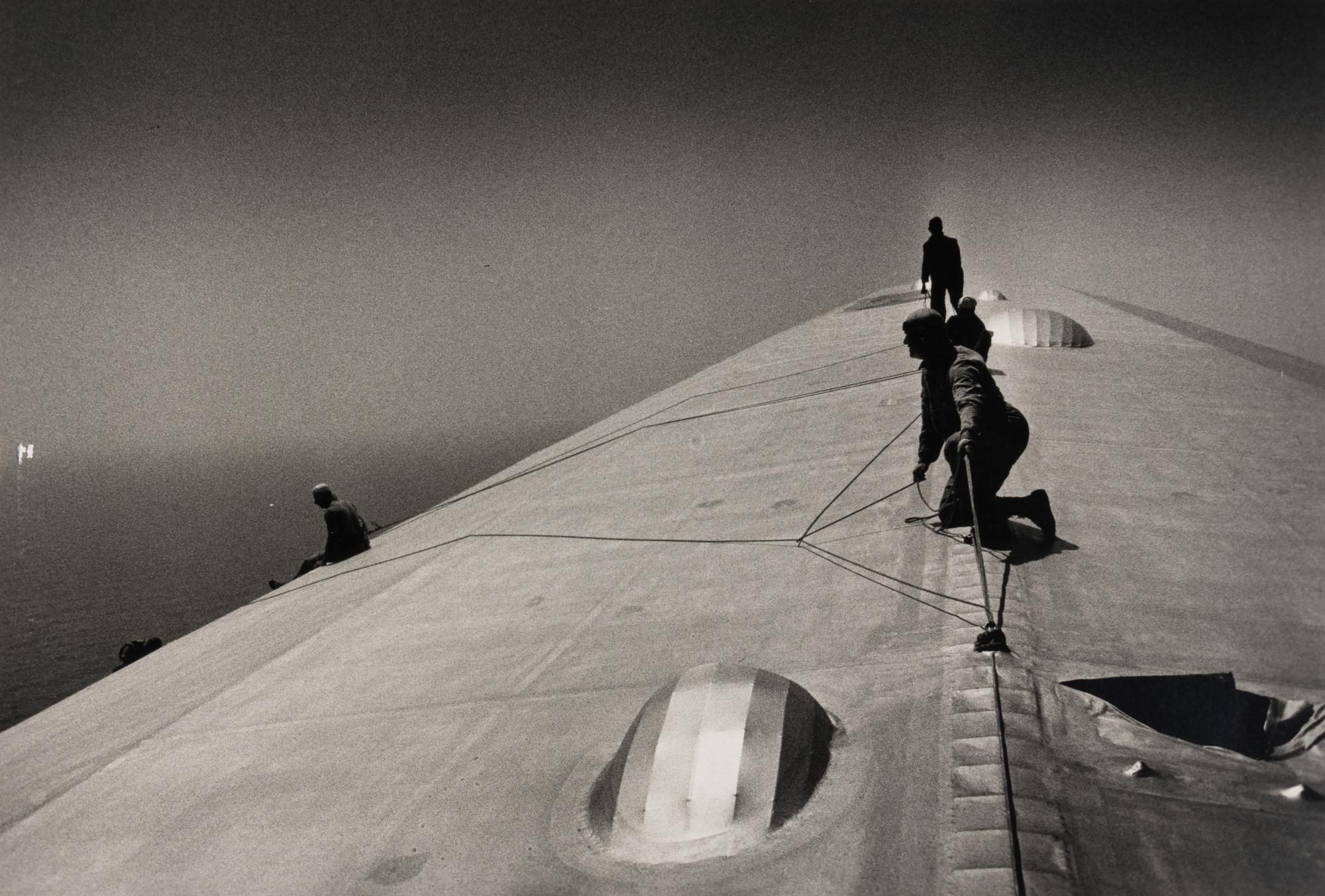 EISENSTAEDT, Alfred (1898-1995). A photograph of workers repairing the hull of the Graf Zeppelin.