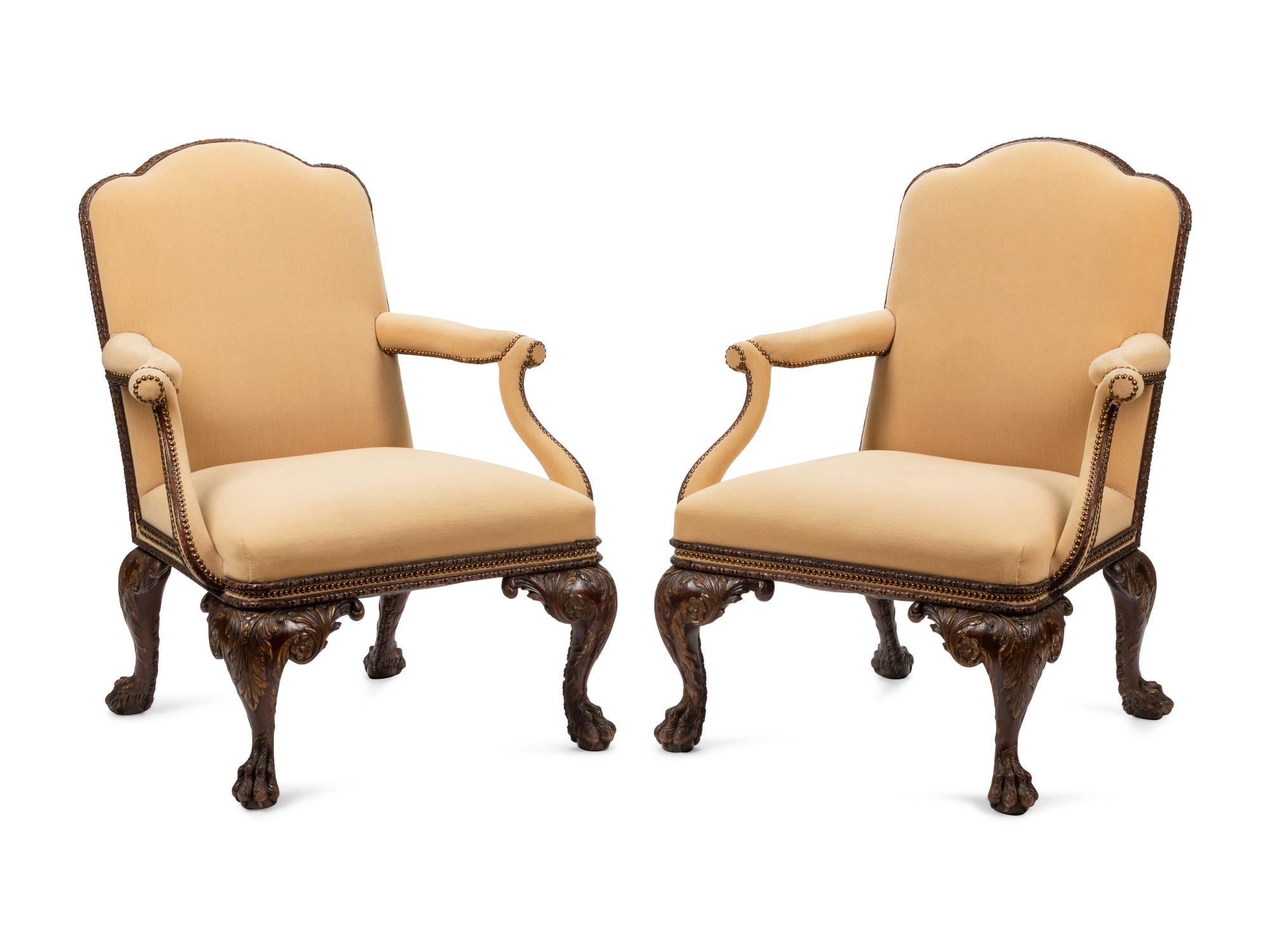A Pair of Irish George II Style Parcel Gilt Carved Mahogany Library Chairs