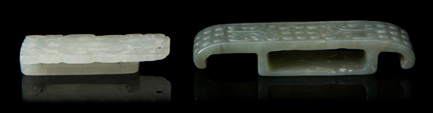 Two Carved Jade Sword Slides Length of larger 2 3/4 inches.