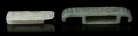 Two Carved Jade Sword Slides Length of larger 2 3/4 inches.