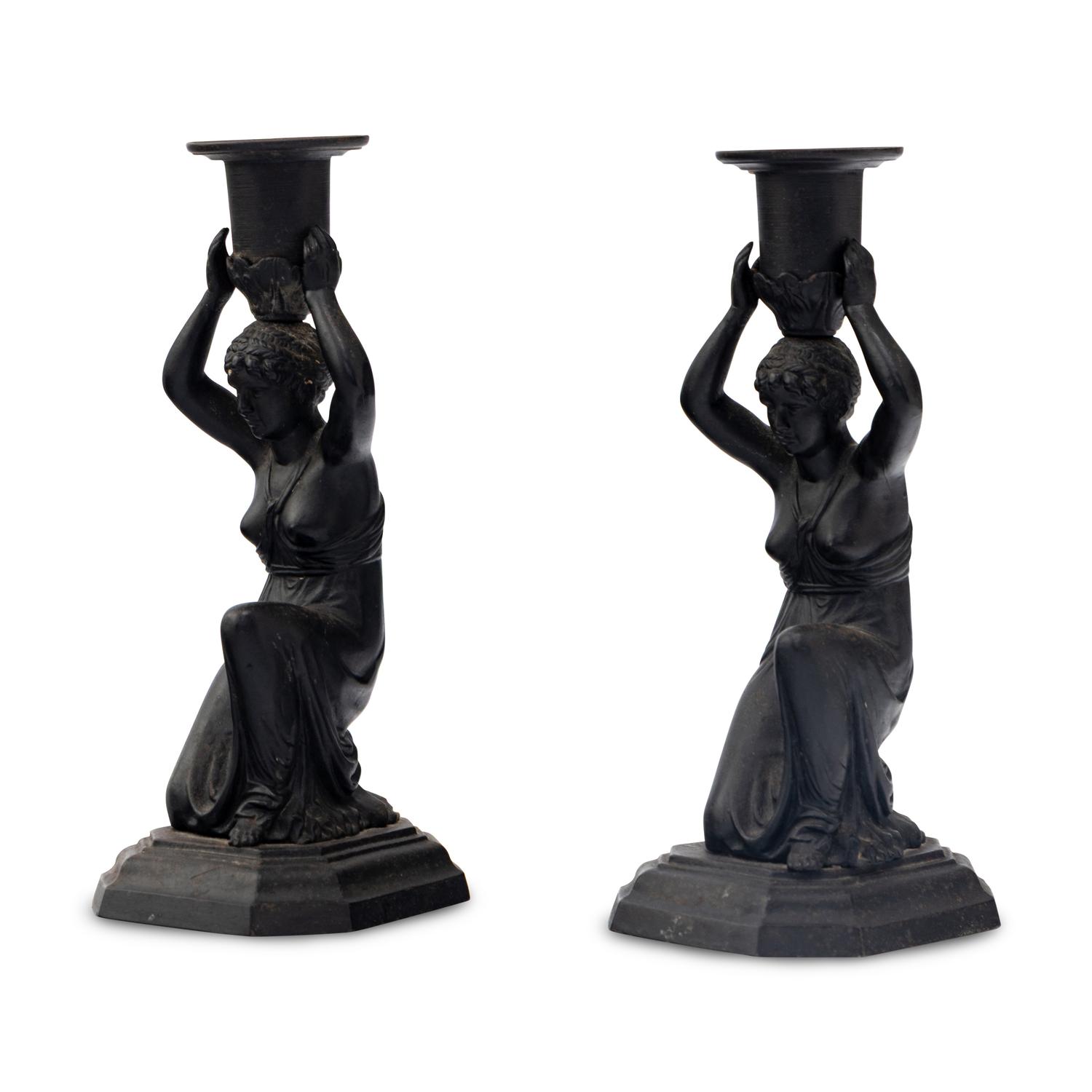 A Pair of Grand Tour Patinated Metal Figural Candlesticks