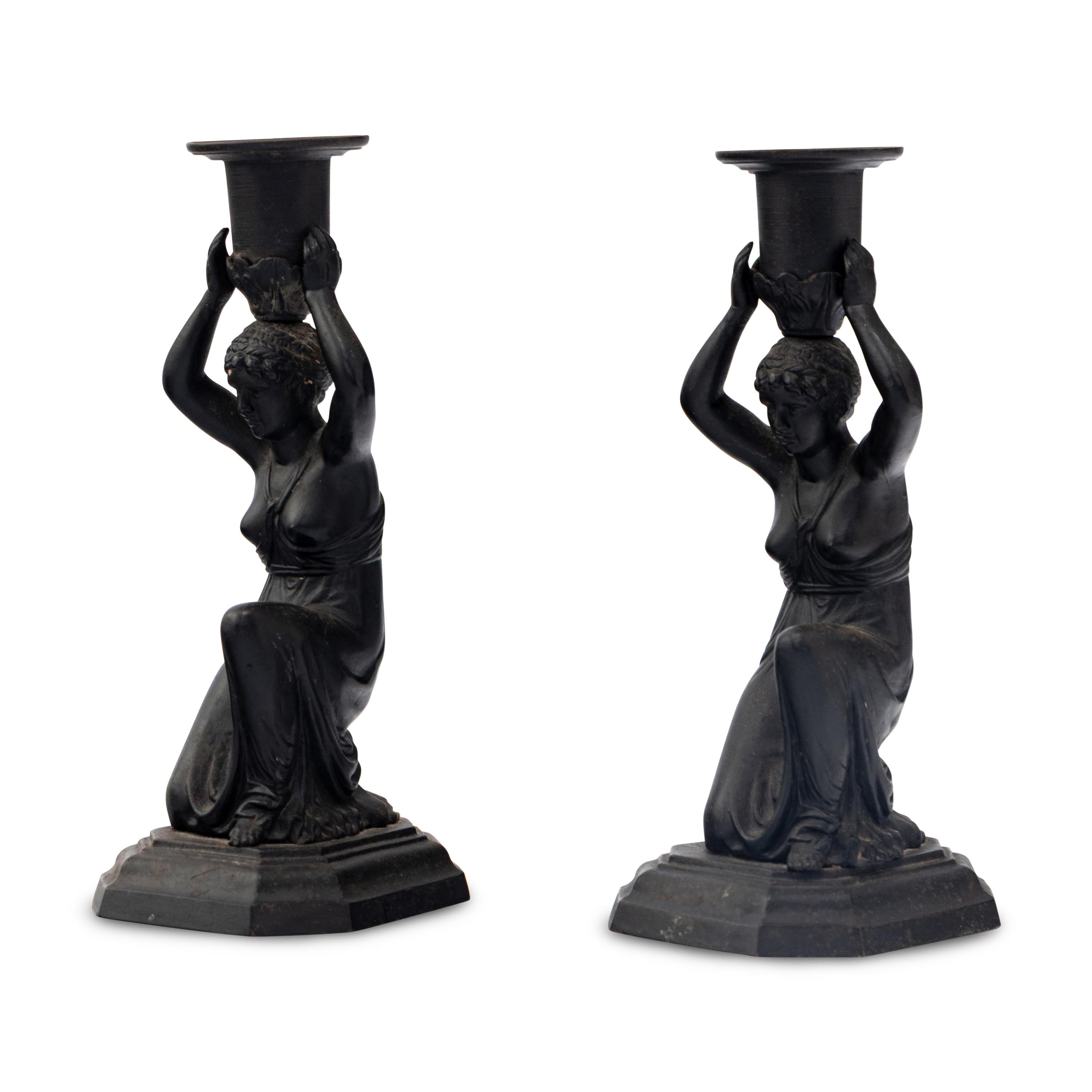 A Pair of Grand Tour Patinated Metal Figural Candlesticks