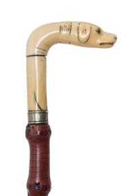 An Austrian Carved Walrus Ivory Handled Cane, Width of handle 3 1/2 x length overall 33 1/2 inches.