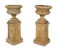 A Pair of Continental Ceramic Urns on Pedestals — EARLY 20TH CENTURY