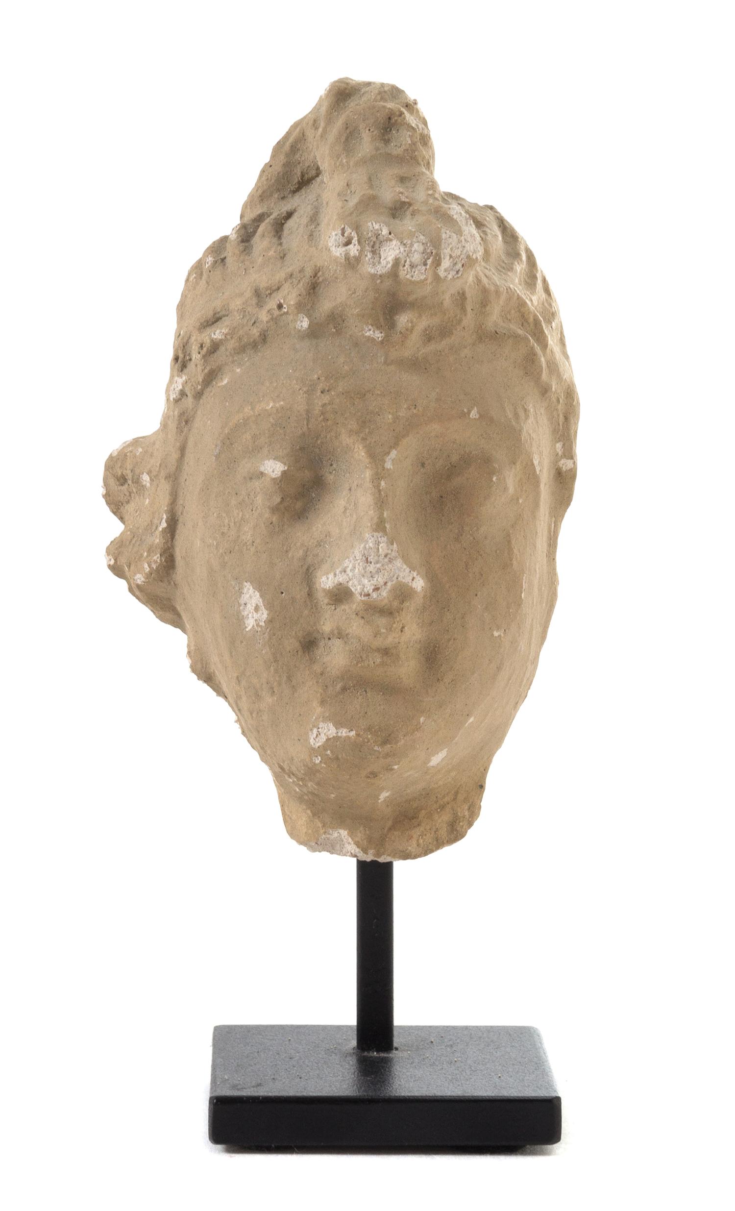 A Gandharan Stucco Head of a Male Height 3 3/4 inches.