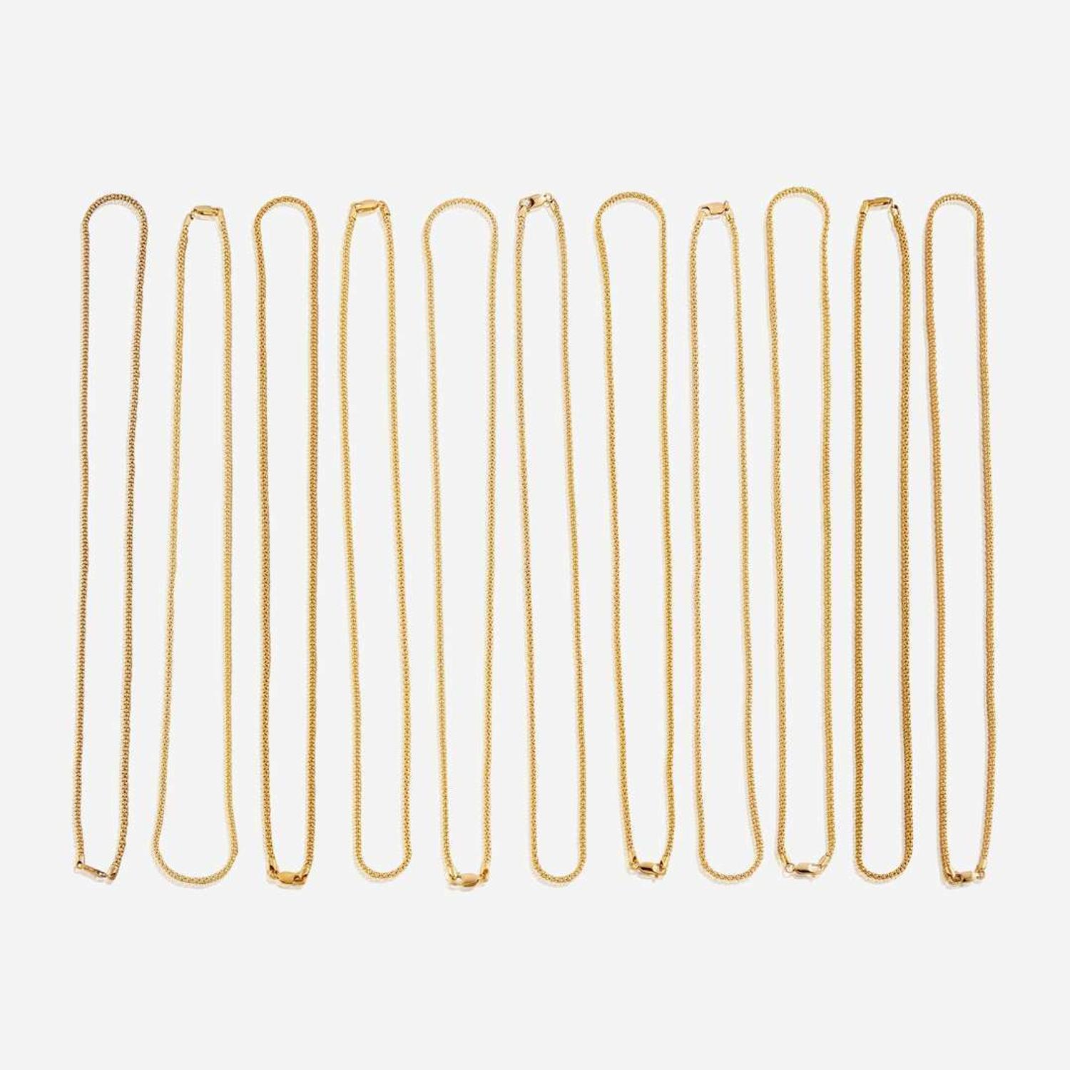 A collection of eleven fourteen karat gold necklaces
