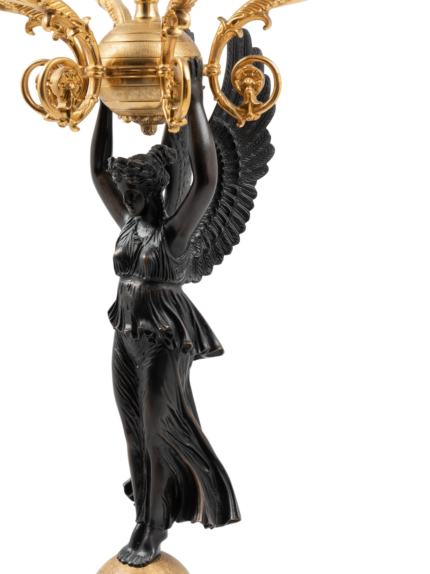 A Pair of Empire Style Gilt and Patinated Metal Six-Light Figural Candelabra