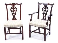 A Set of Twelve Hepplewhite Style Carved Mahogany Dining Chairs Height 37 1/2 inches. — 20TH CENTURY