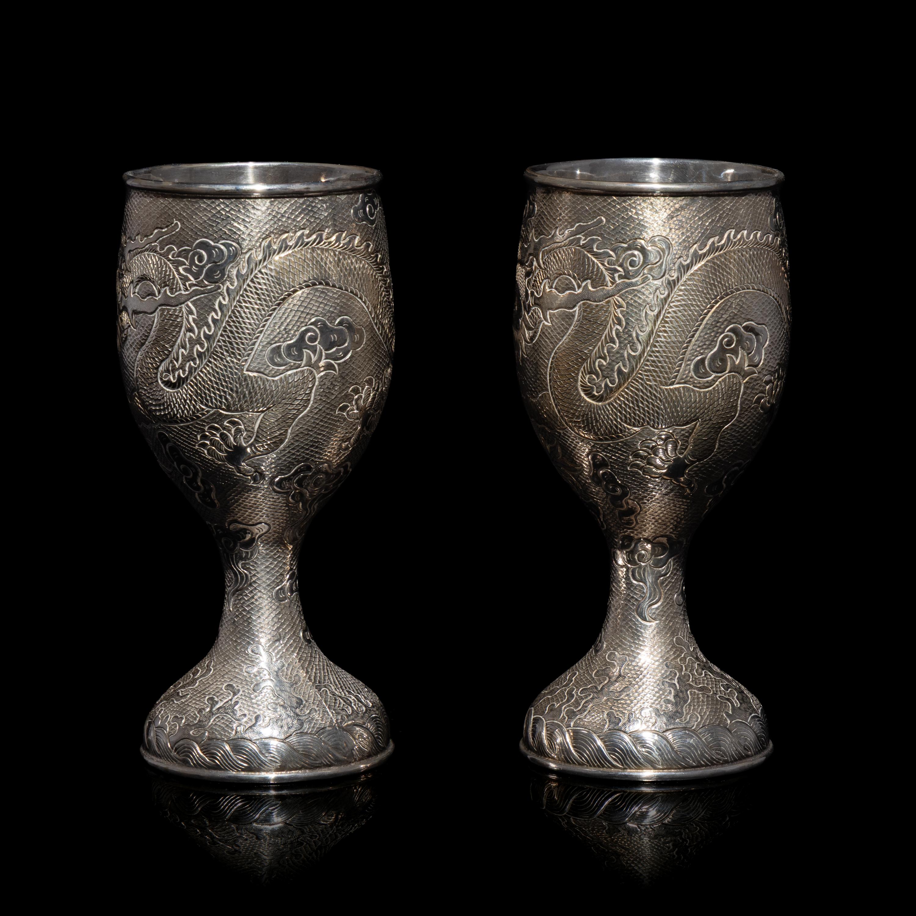 A Pair of Chinese Export Silver 'Dragon' Wine Cups, 20th Century 近代 外銷鏨云龍紋酒杯一對