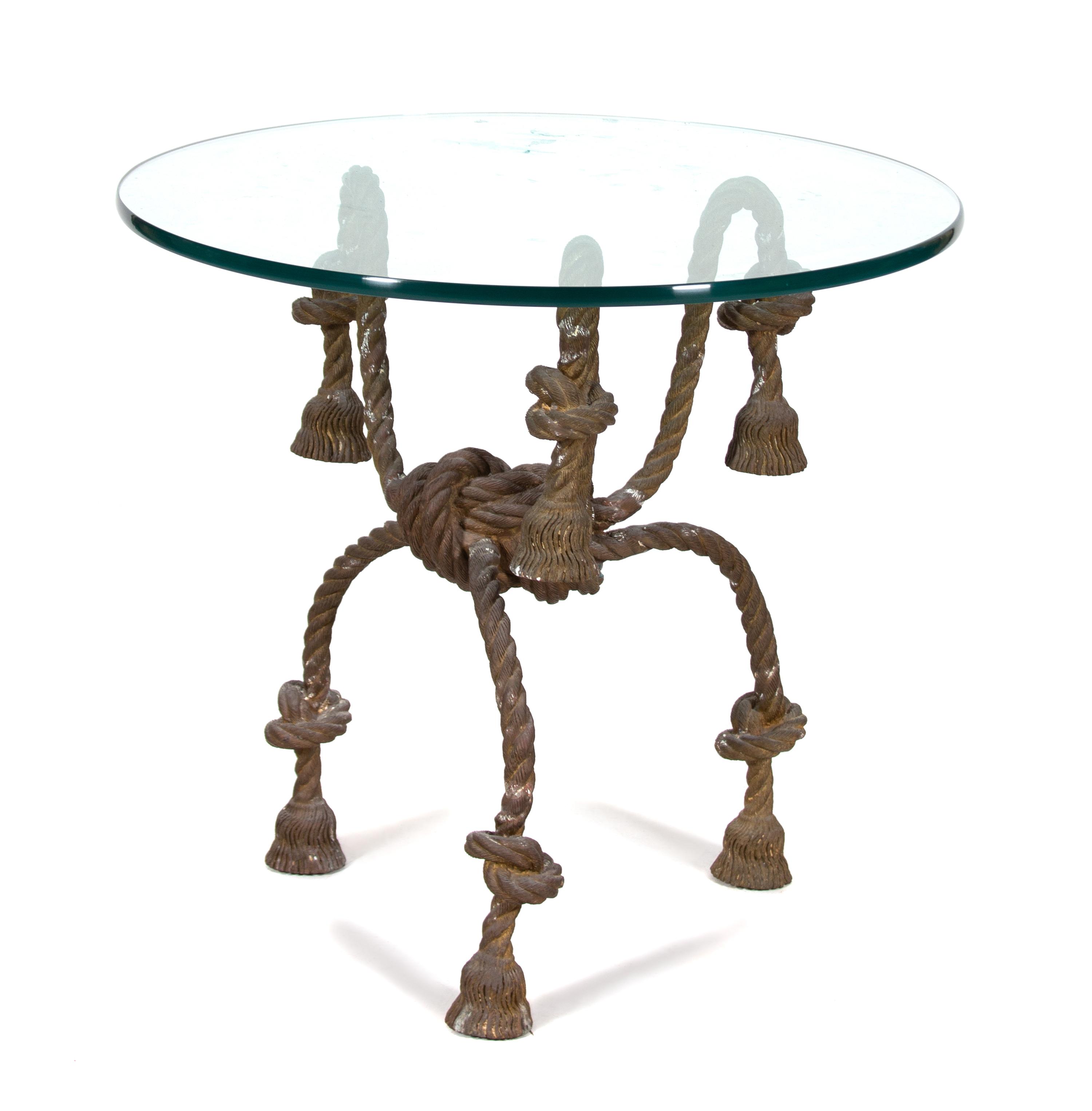 An Italian Gilt Metal Rope and Tassle Glass Top Table Height 29 1/2 x diameter 32 1/2 inches. — 20TH CENTURY