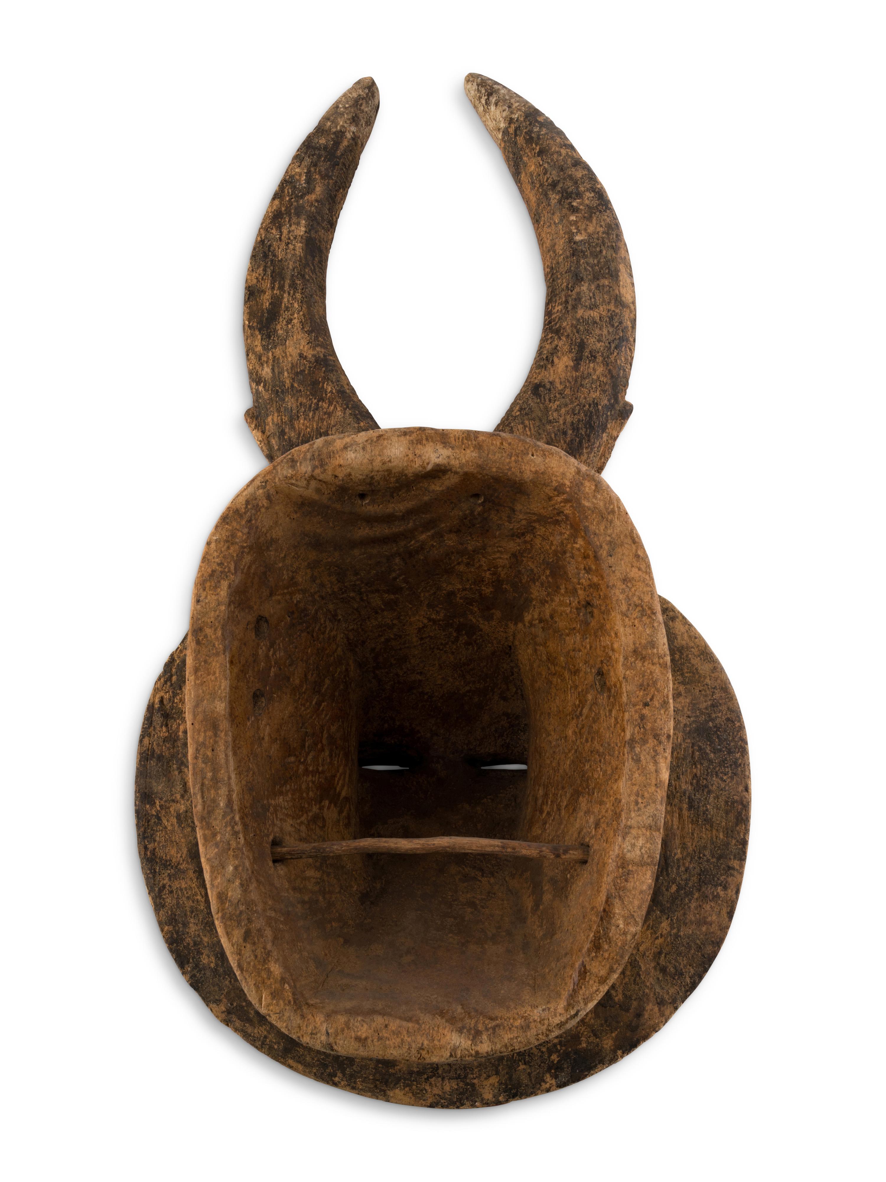 An African Carved Wood Horned Sun Mask