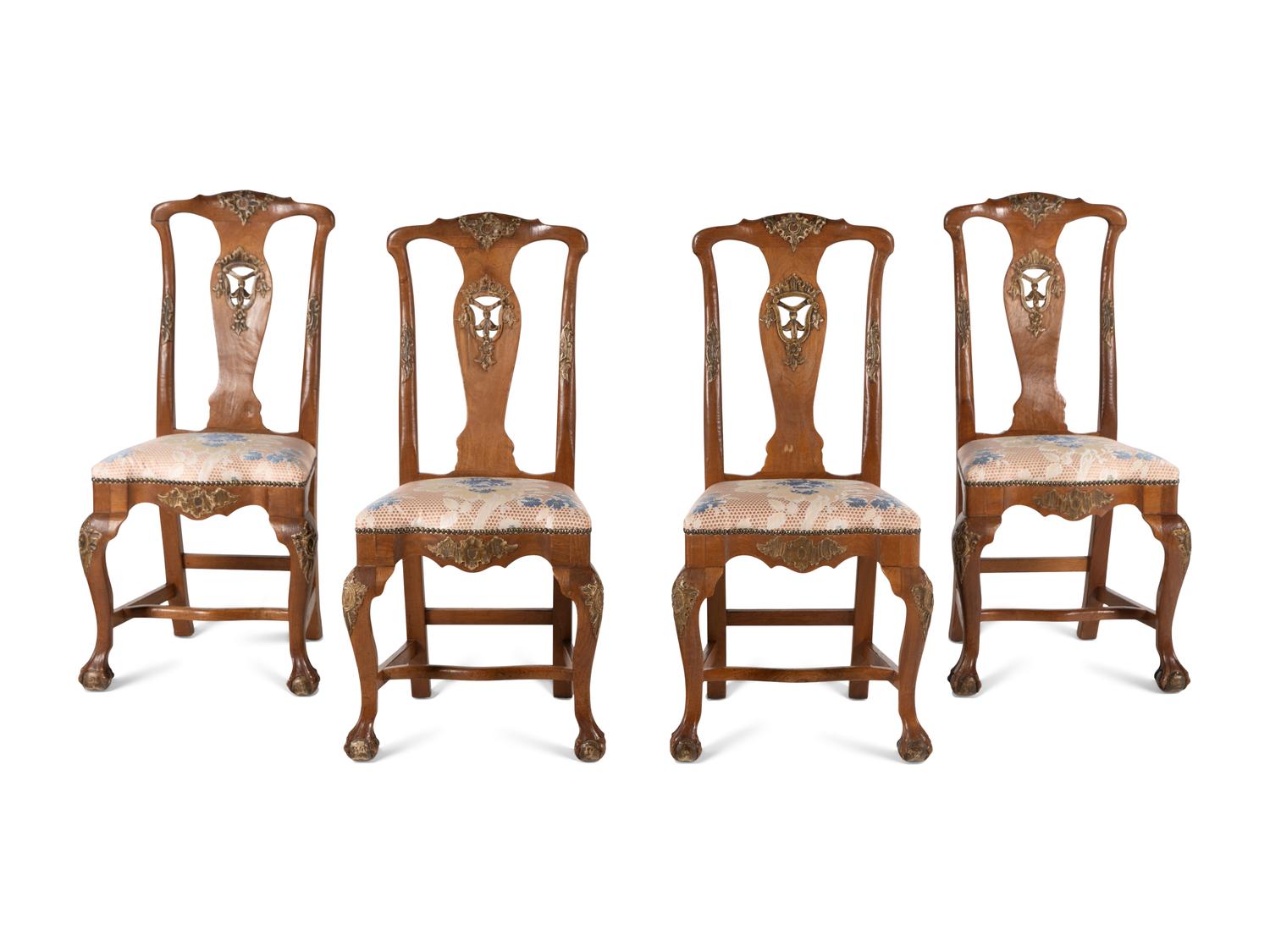 A Set of Four Dutch Parcel-Gilt Walnut Side Chairs